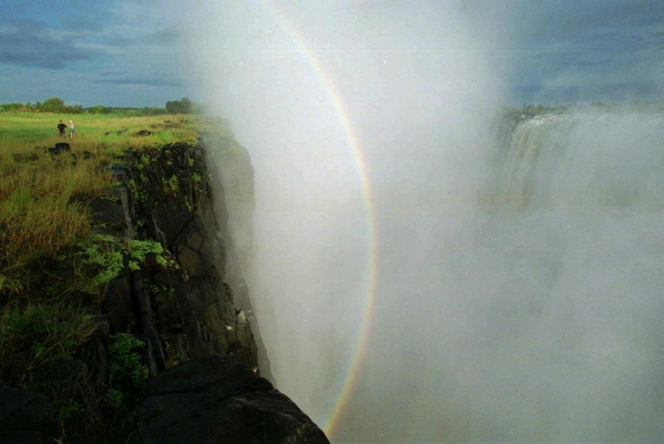 A rainbow highlights mist from the Zambezi River, Africa's fourth largest river, at Victoria Falls. The native name for the falls translates as "the smoke that thunders."