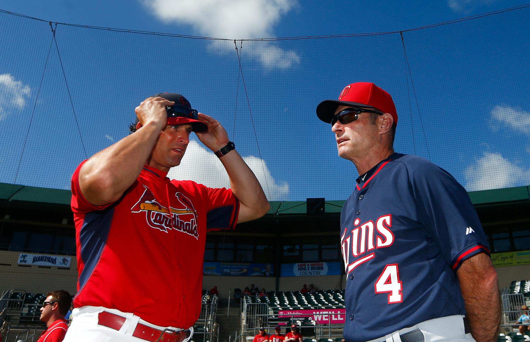 St. Louis Cardinals manager Mike Matheny and Minnesota Twins manager Paul Molitor (4) chat before an exhibition spring training baseball game Saturday, March 14, 2015, in Jupiter, Fla. (AP Photo/John Bazemore)