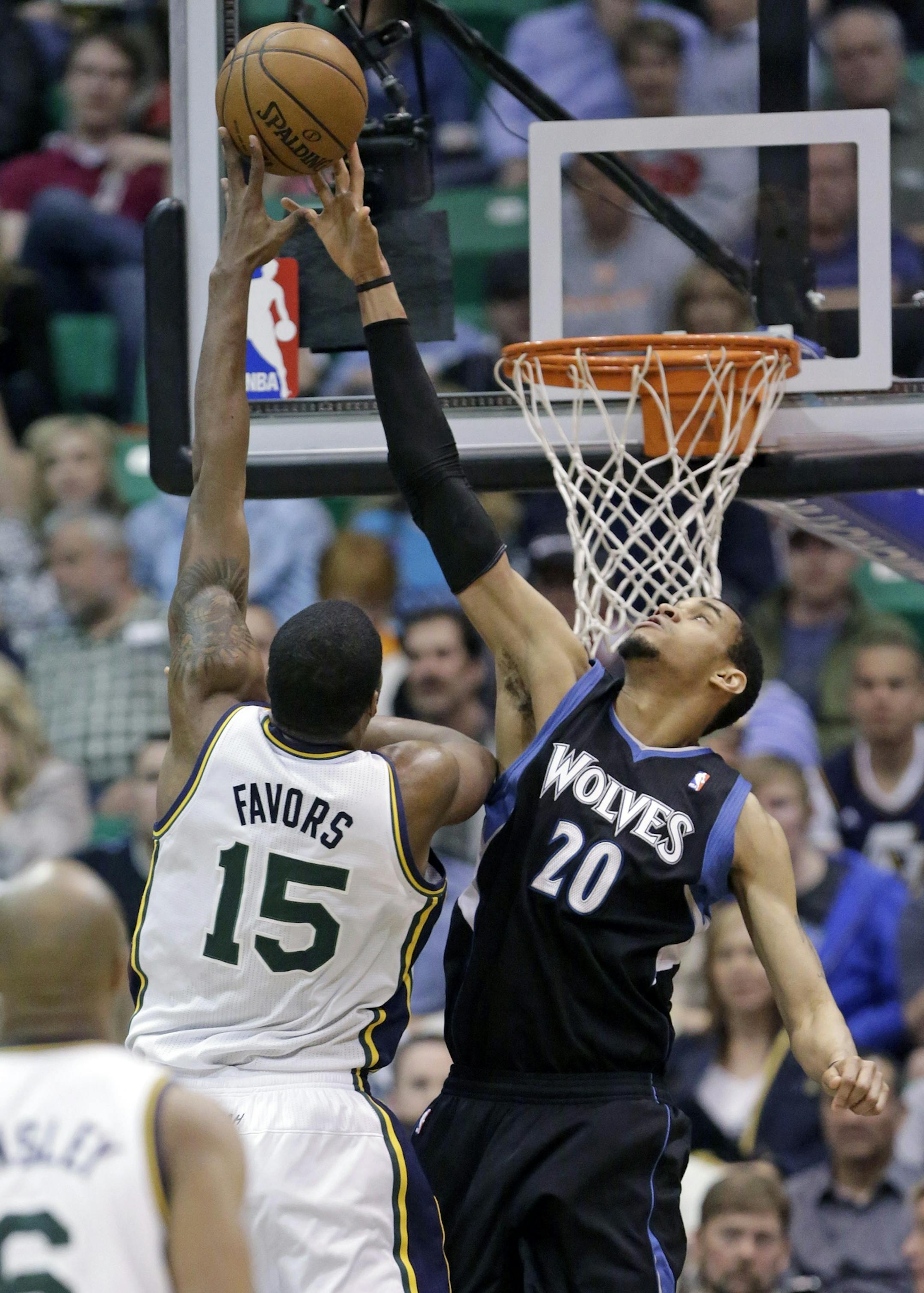 Minnesota Timberwolves' Chris Johnson (20) defends against Utah Jazz's Derrick Favors (15) in the second quarter during an NBA basketball game on Friday, April 12, 2013, in Salt Lake City. (AP Photo/Rick Bowmer)