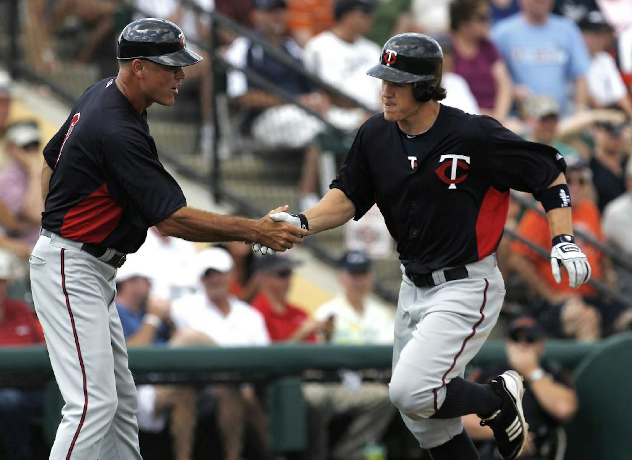 Twins outfield prospect Joe Benson was congratulated by third base coach Steve Liddle after hitting a two-run homer in the fifth inning of a 7-3 victory Tigers at Lakeland, Fla., on Wednesday.