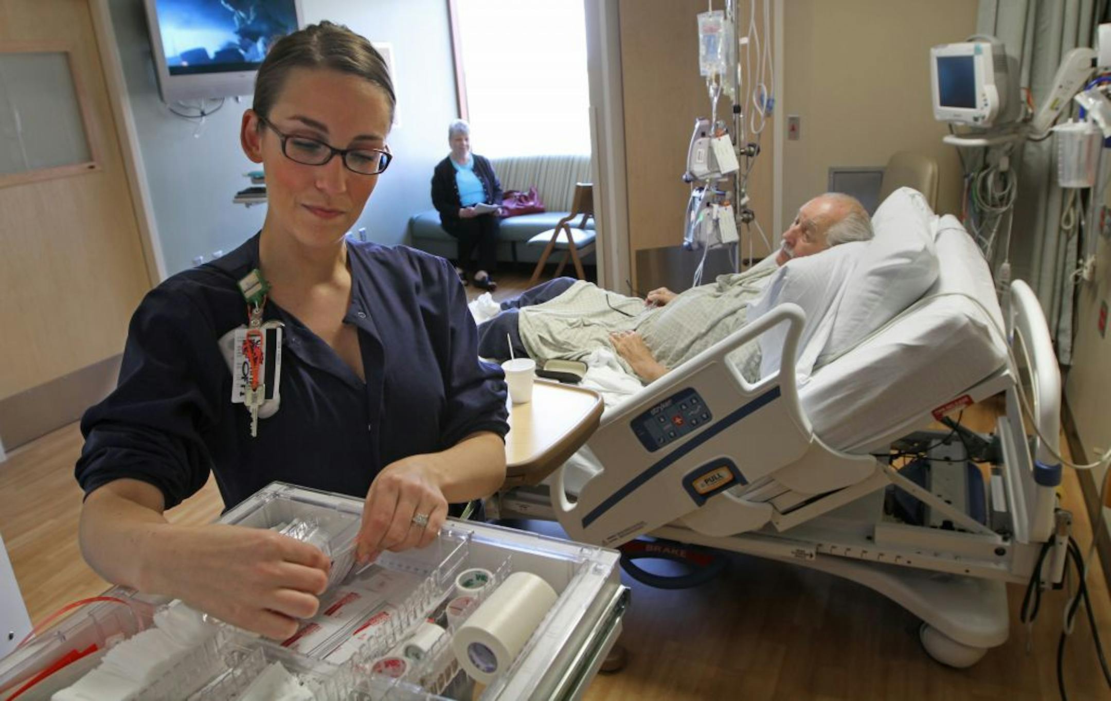 Maple Grove Hospital RN Jessica Stifter checked the medical supply cabinet as he cared from Terry McCann, of Brooklyn Park on 5/31/12. Joanne McCann, wife of Terry, was visiting.