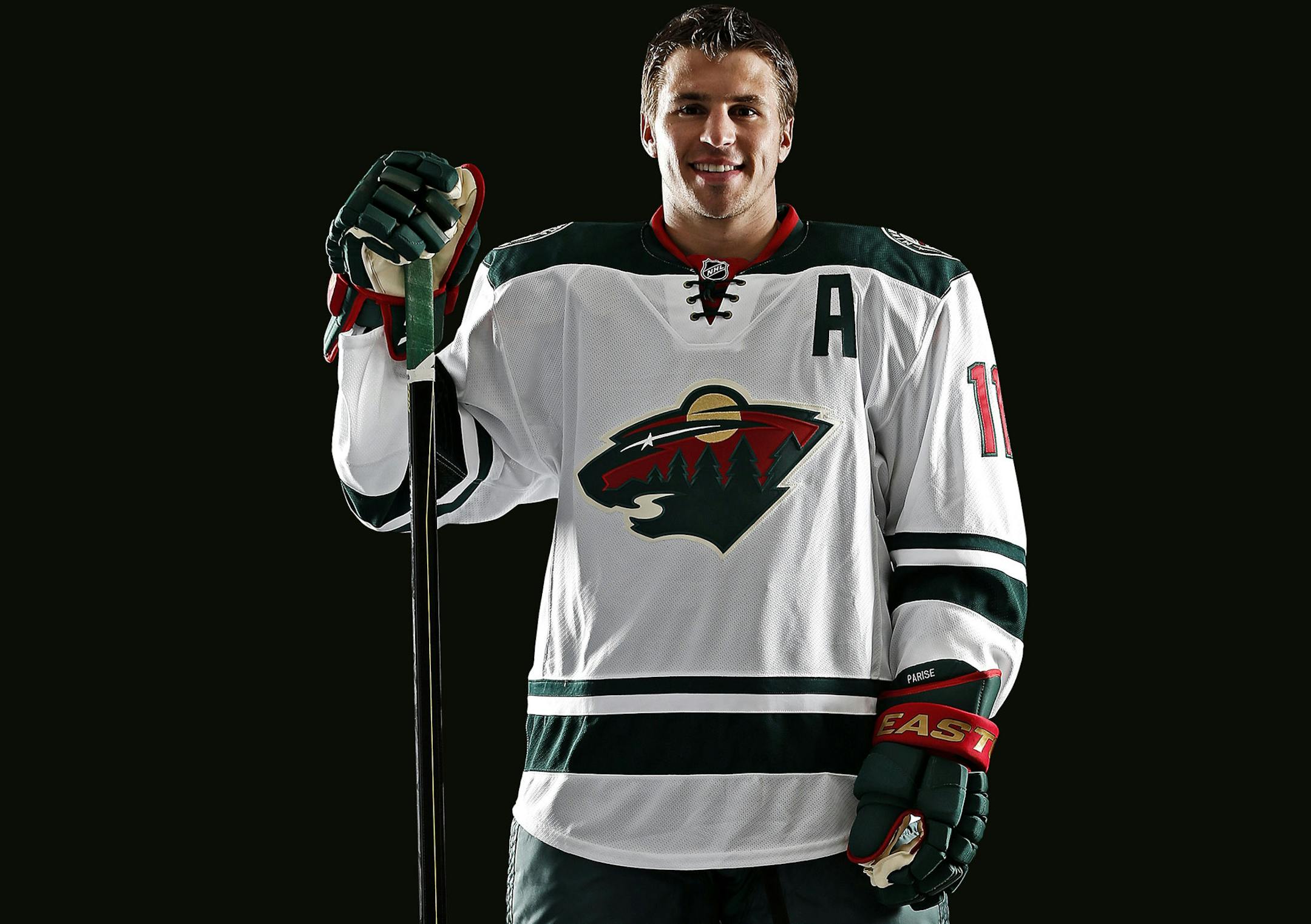 Minnesota Wild forward Zach Parise showed off the team's new road white jerseys.