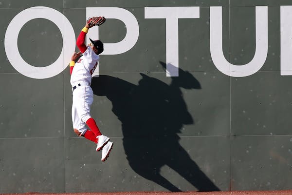 Boston Red Sox's Mookie Betts makes the catch on the fly out by New York Yankees' Edwin Encarnacion during the second inning of a baseball game in Bos