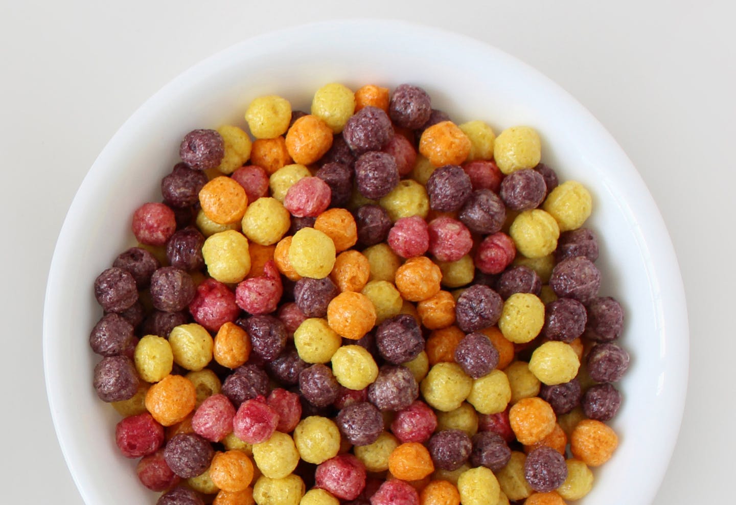 This undated photo combination provided by General Mills shows a bowl of Trix cereal made with artificial colors, left, and a bowl with natural colors, right. Food makers are purging their products of artificial dyes as people increasingly eschew anything in their food they don&#xed;t feel is natural. General Mills couldn&#xed;t find good alternatives for the blue and green pieces in Trix, so the company is getting rid of those colors when the cereal is reformulated later this year. The red piec