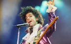 FILE - In this Feb. 18, 1985 file photo, Prince performs at the Forum in Inglewood, Calif. A year after Prince died of an accidental drug overdose, hi