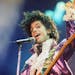 FILE - In this Feb. 18, 1985 file photo, Prince performs at the Forum in Inglewood, Calif. A year after Prince died of an accidental drug overdose, hi