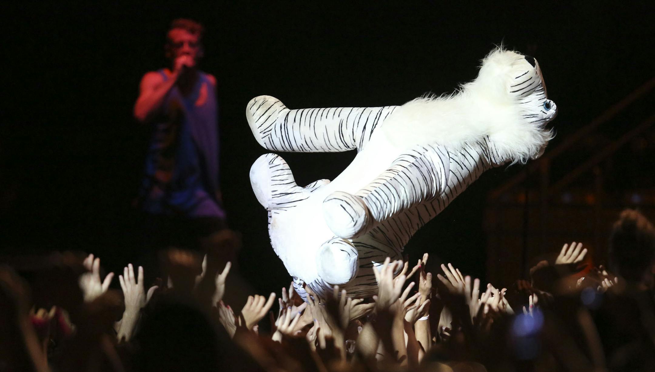Macklemore danced with a stuff tiger as he and Ryan Lewis performed at the Minnesota State Fair Grandstand in Falcon Heights Min., Saturday, August 30, 2013. ] (KYNDELL HARKNESS/STAR TRIBUNE) kyndell.harkness@startribune.com Macklemore threw the stuffed tiger he danced with back into the crowd back it it's owner as he and Ryan Lewis performed at the Minnesota State Fair Grandstand in Falcon Heights Min., Saturday, August 30, 2013. ] (KYNDELL HARKNESS/STAR TRIBUNE) kyndell.harkness@startribune.co