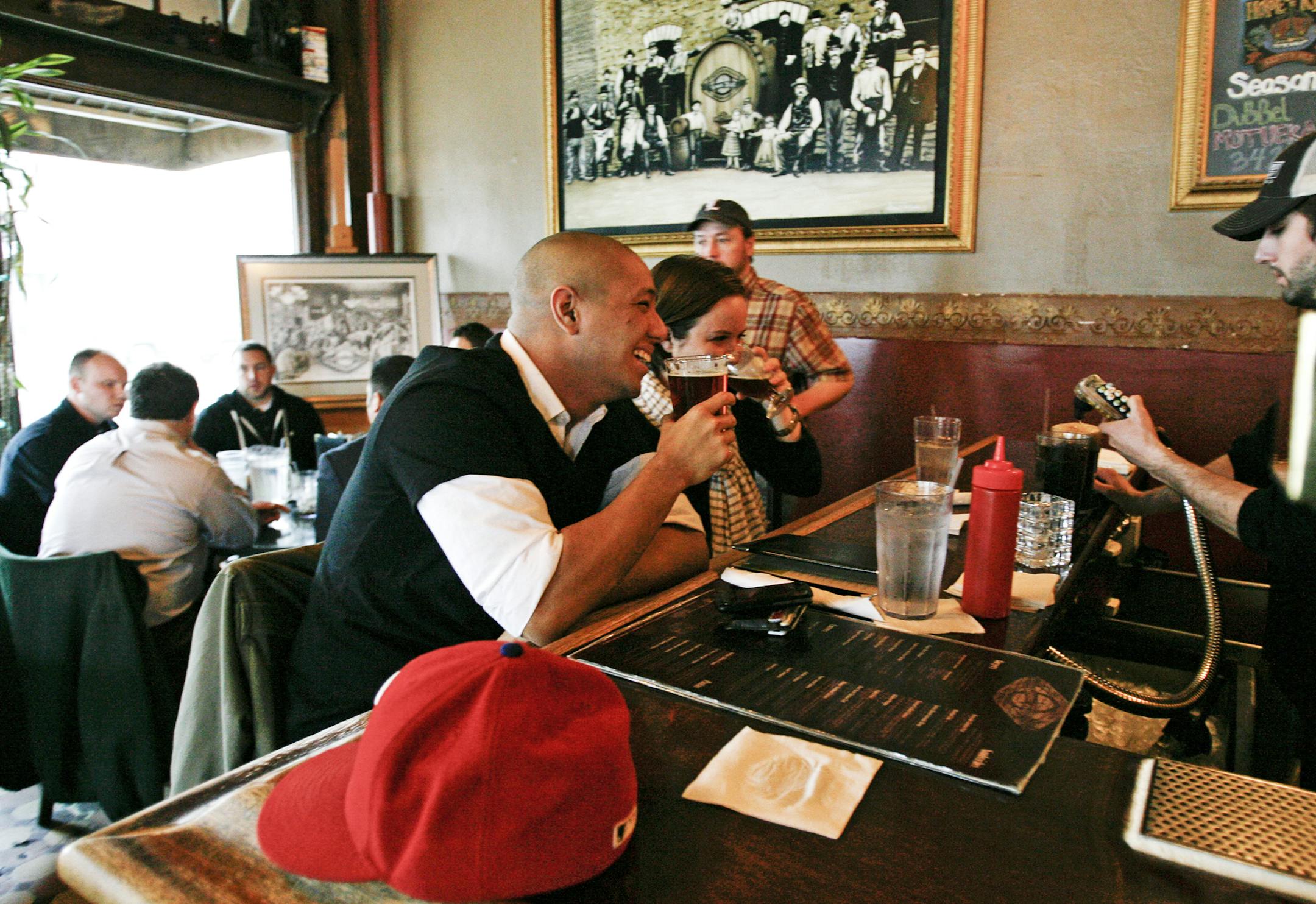 Former school mates Ryan Rahinel, left, and Noelle Nelson enjoyed beers over lunch at Town Hall Brewery Wednesday, March 7, 2012, in Minneapolis, MN. Rahinel enjoyed a 342 and Nelson a Twisted Jim - both specialty beers brewed at Town Hall.] DAVID JOLES*djoles@startribune.com - Microbreweries are gearing up for a legislative fight. They want to be able to sell their products wholesale. The state's liquor lobby is likely to put up a fight. Last year, Minnesota breweries won the right to open on-s