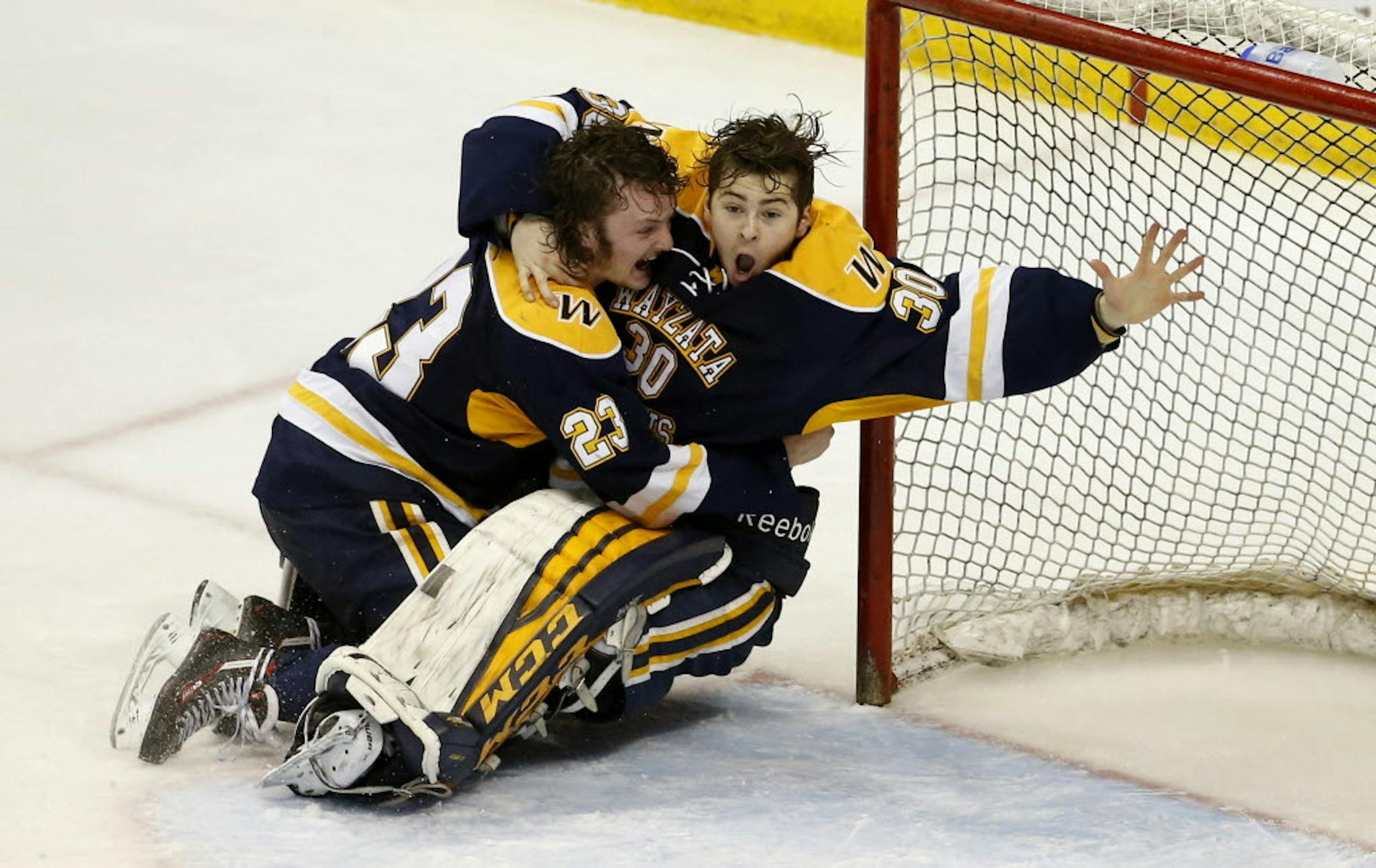 Wayzata defenseman Hank Sorensen tackled goaltender Alex Schilling in celebration after the Trojans, behind stellar play from Schilling in the second half of the game, defeated Eden Prairie 5-3 to win the Class 2A state tournament championship on Saturday at Xcel Energy Center in St. Paul.
