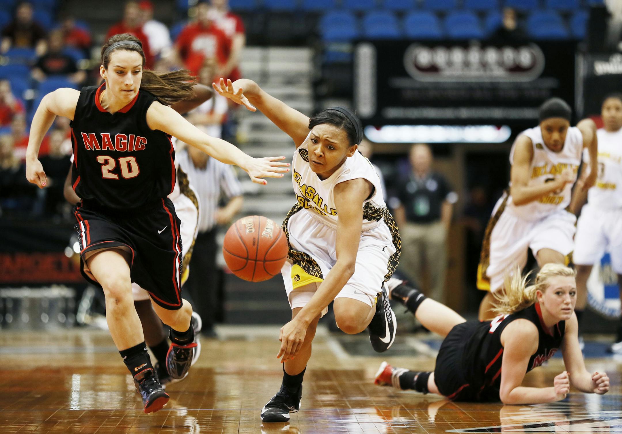 Tyseanna Jonson of DeLaSalle rain down court after stealing the ball from Kallie Gau of Monticello during Class 3A girls' semifinals March, 14, 2012 at Target Center