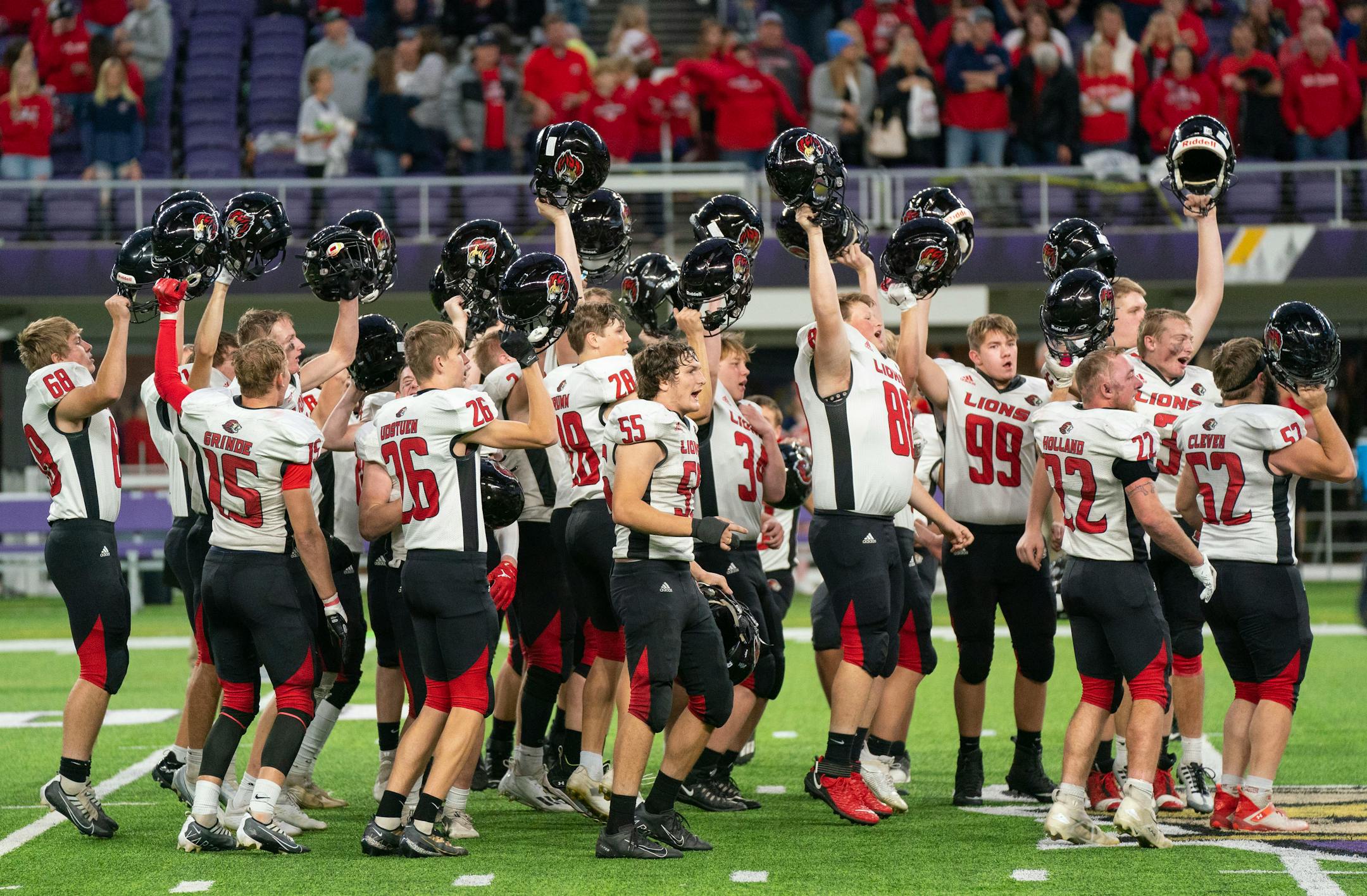 Spring Grove players celebrate after defeating Fertile-Beltrami 27-6 in a Nine-Man semifinal playoff game Thursday