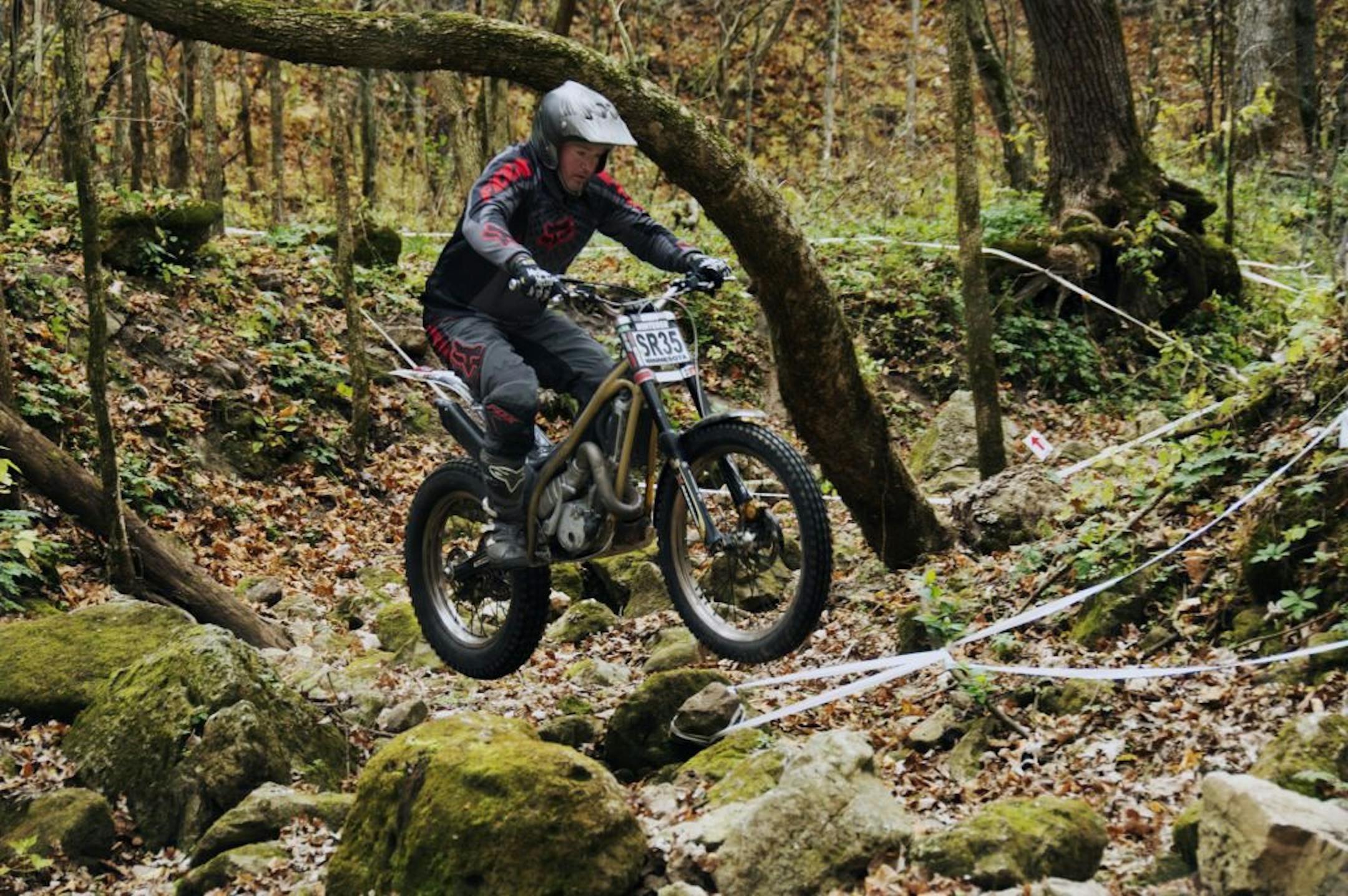 Ben Winterer guided his motorcycle through a narrow course at a MotoTrial site near Theilman, Minn. Winterer, 35, of Hastings, was diagnosed with cystic fibrosis as an infant. He and his doctor both credit his vigorous motorcycle competition with helping him combat symptoms of the disease.