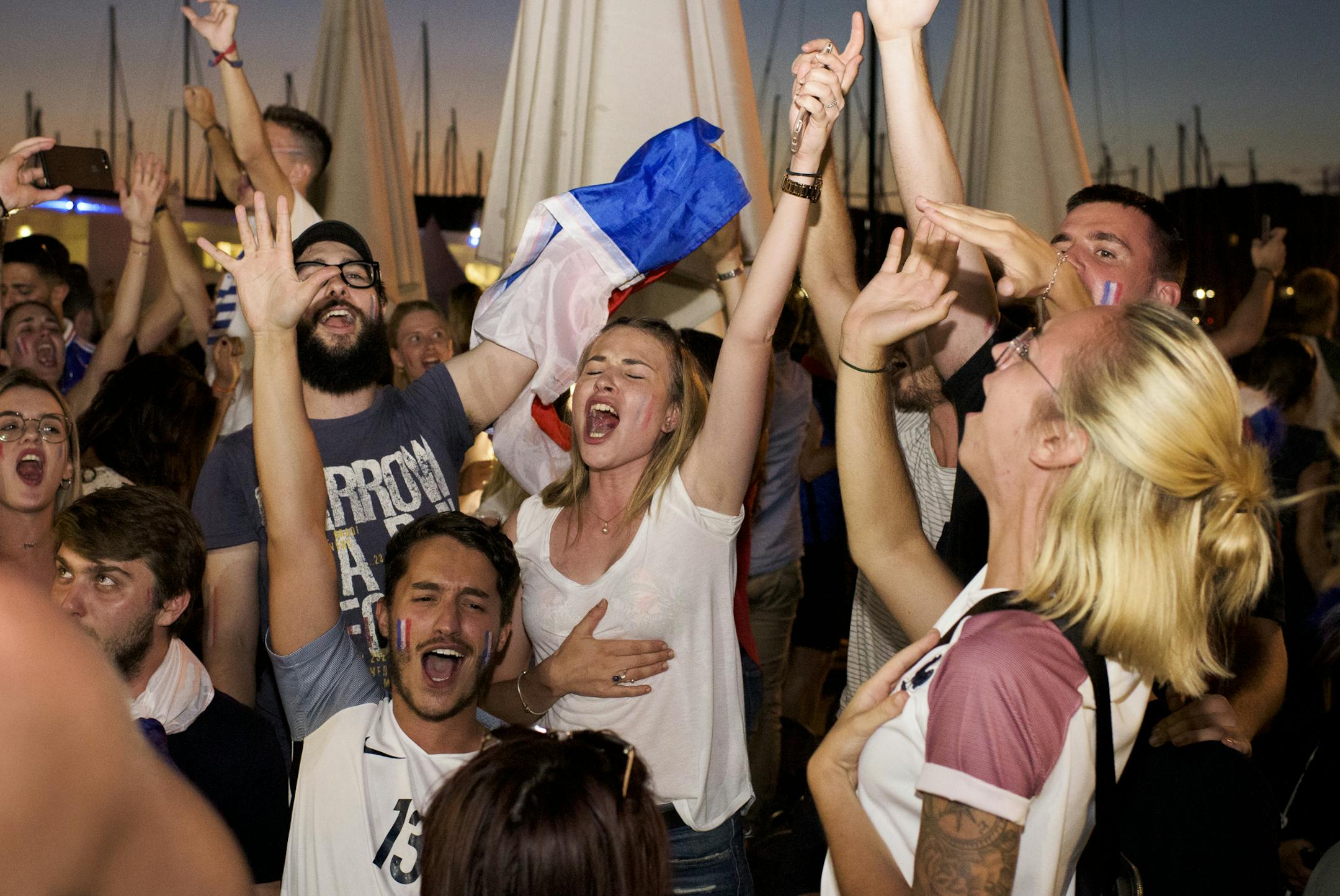 Fans celebrate by dancing and chanting following France's 1-0 victory in the World Cup semifinal against Belgium, in Marseille, July 10, 2018. For countries reaching the latter stages, the World Cup becomes something of a national fixation, sweeping along even those who have little or no interest in sports, and people come together to watch as one. (Pete Kiehart/The New York Times)