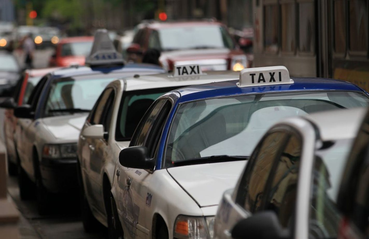 Taxi cabs lined the streets at taxi waiting areas in downtown Minneapolis on Friday, May 4, 2012 in Minneapolis, Minn. The number of cabs has doubled since 2007.