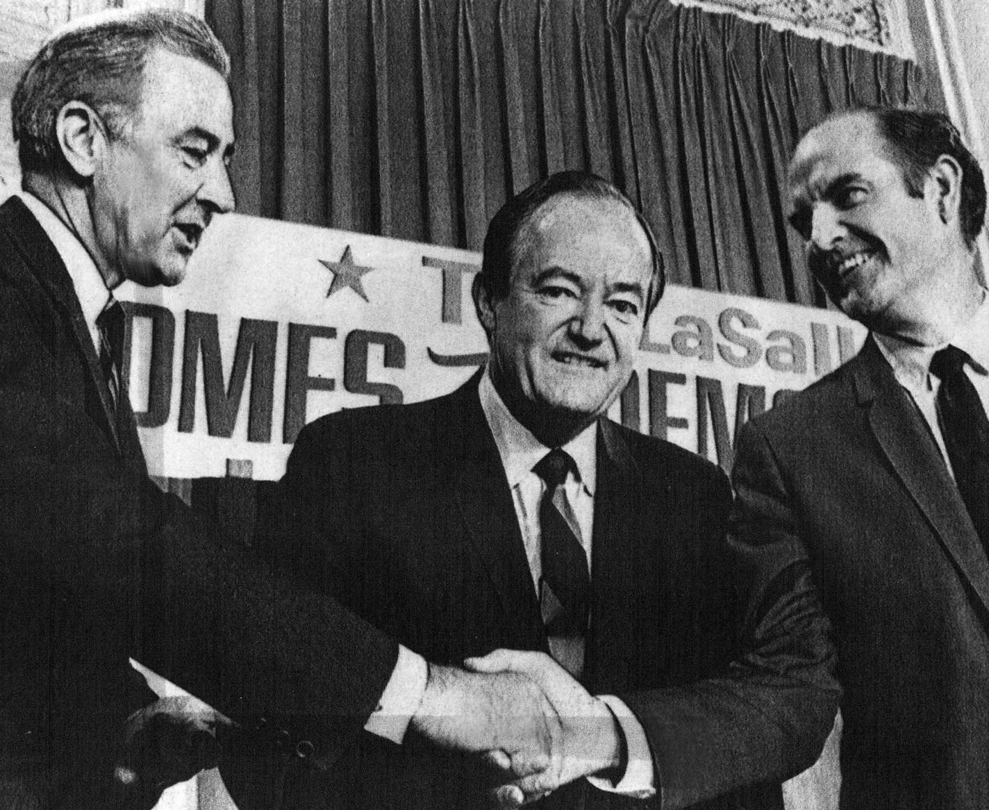 Minnesota Sen. Eugene McCarthy (far left) shakes hands with South Dakota Sen. George McGovern (right) as Vice President Hubert Humphrey, also a Minnesotan, looks on in this August 28, 1968 photo.