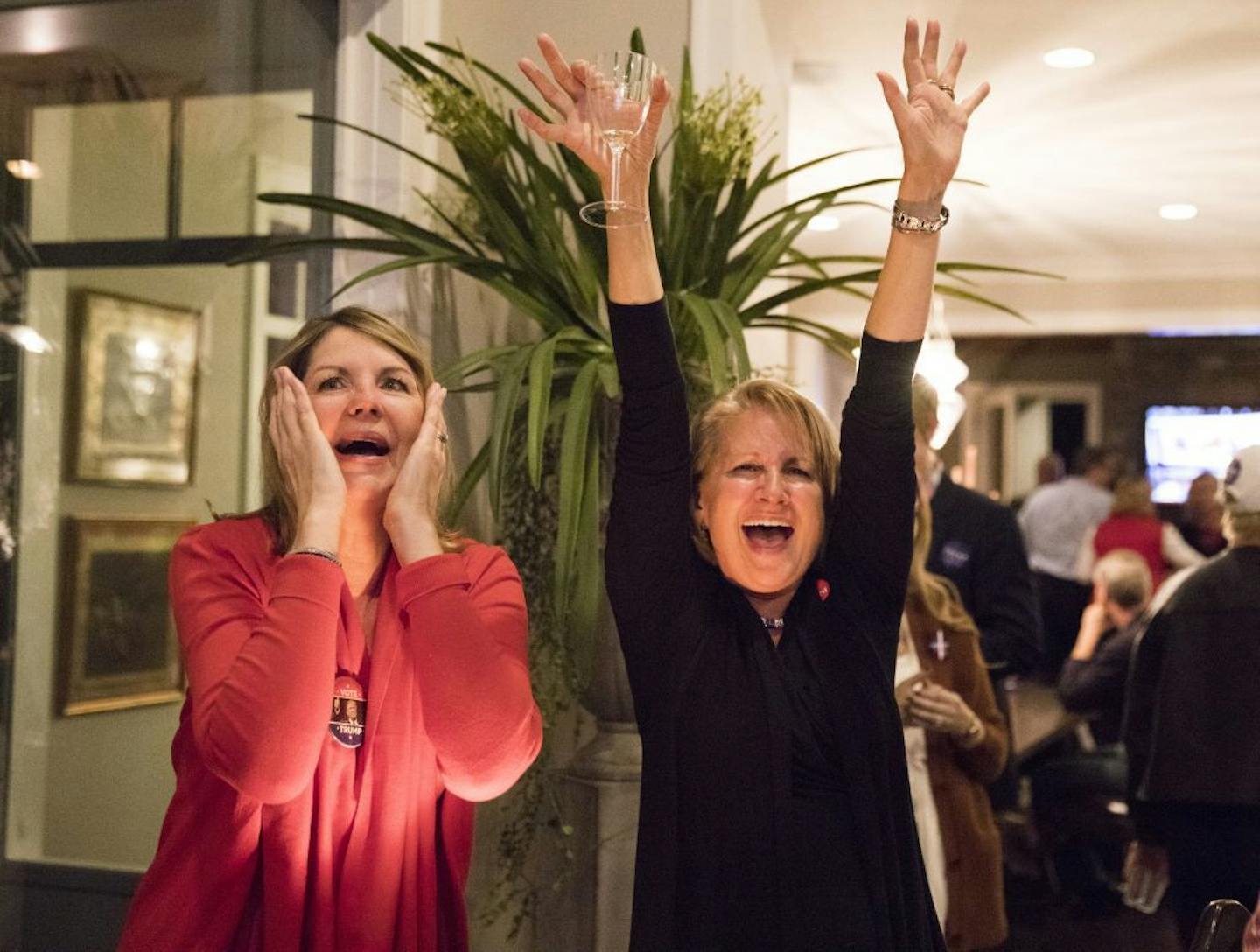 Trump supporters Audrey Fresh, left, and Holly Olson cheer during an election results watch party for Donald Trump supporters.