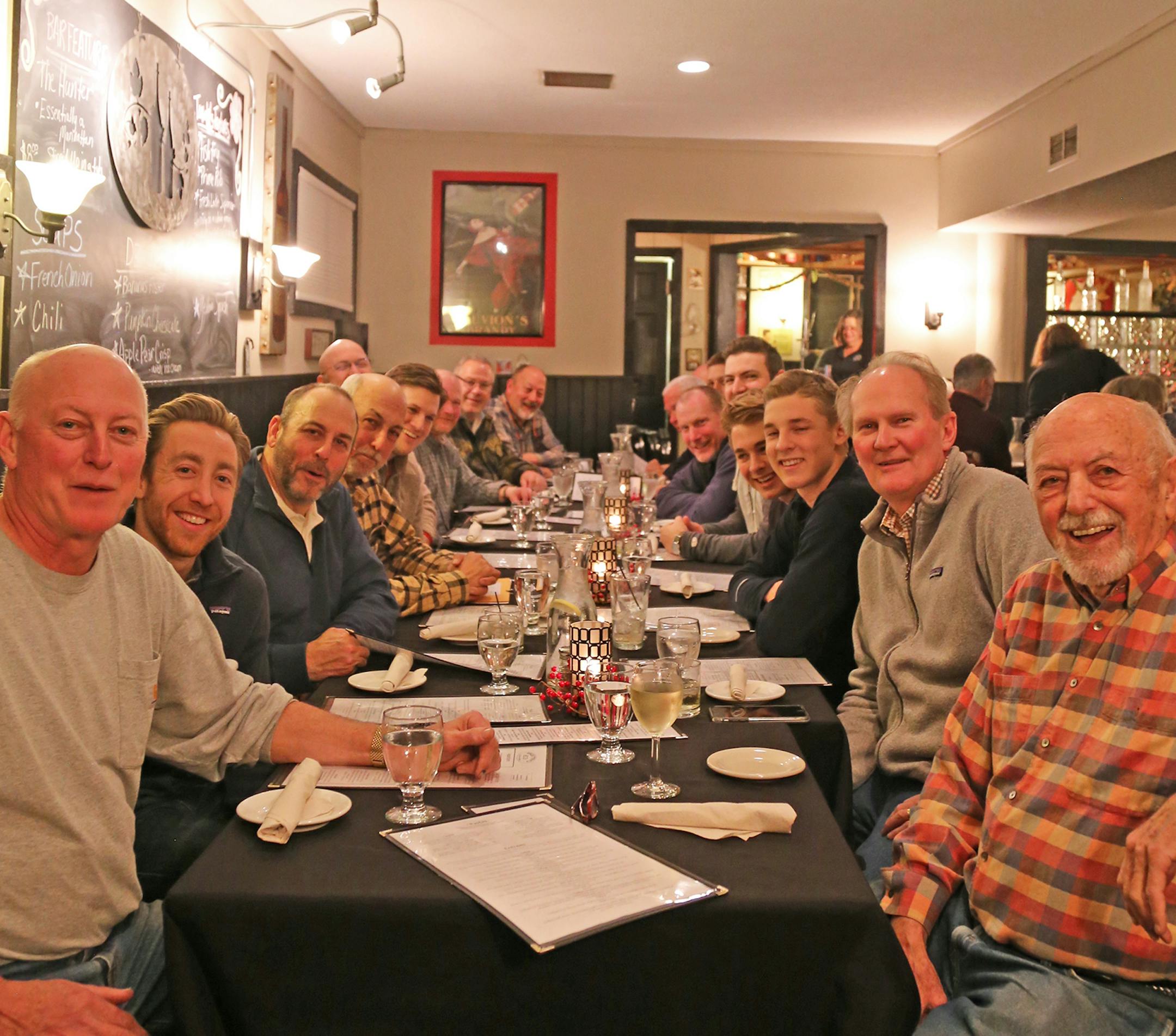 TRADITIONAL PRE-HUNT DINNER: For more than 40 years, Berg family members, headed by patriarch Norb Berg of St. Paul, right, have gathered with relatives and friends to hunt deer not far from Cumberland, Wis. This weekend, 16 hunters took to the woods Saturday morning.