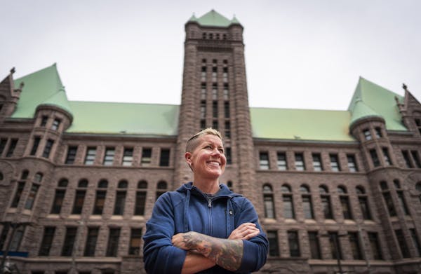 Katie Miller, the new LGBTQIA+ Community Navigator at the Minneapolis Police Department, poses for a photo outside of Minneapolis City Hall. ] LEILA N