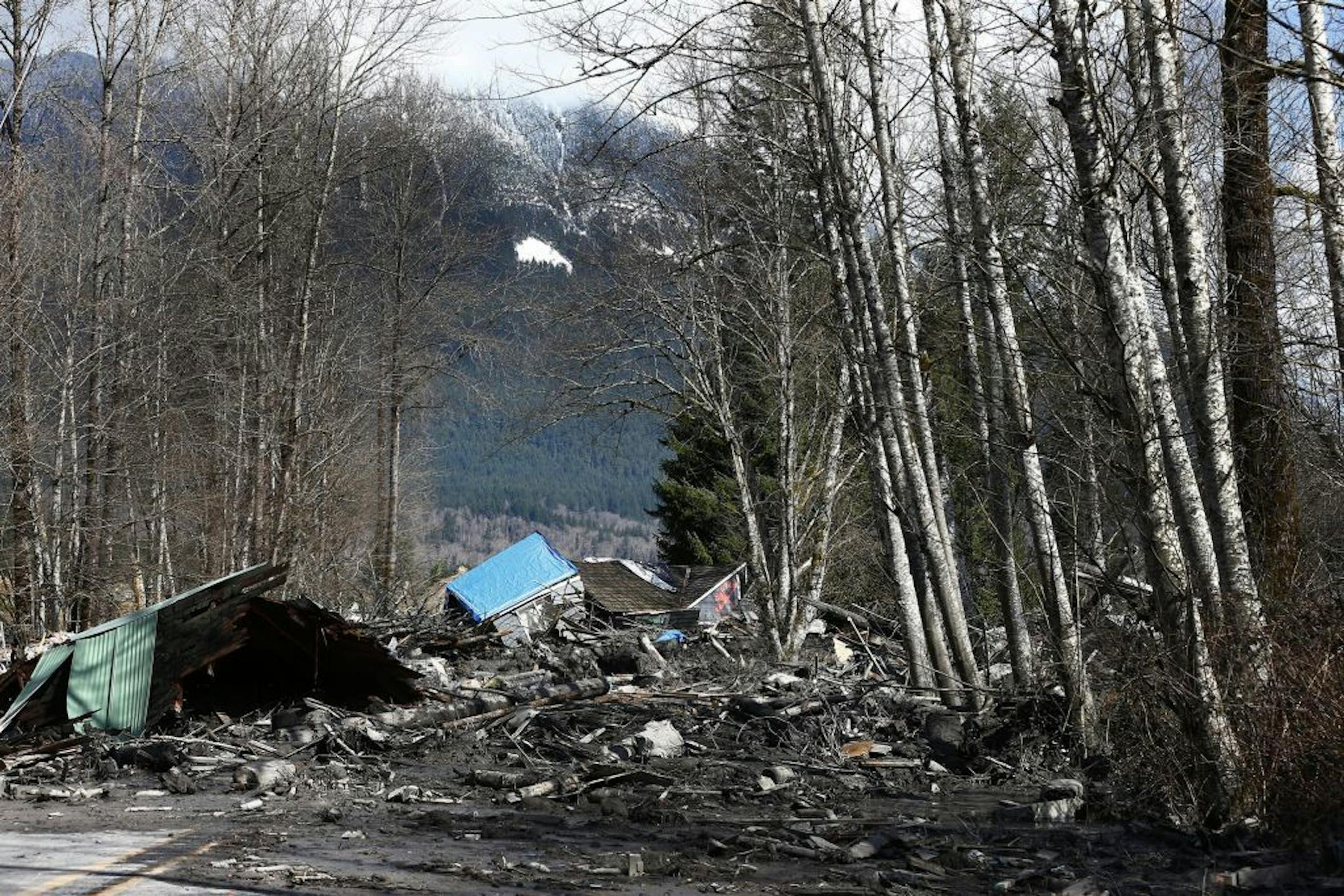 A demolished house is strewn in the mud across Washington State Route 530 in Oso, near Arlington, Wash., March 23, 2014. The search for survivors at the site of the landslide continues with the growing fear that rescue workers will find more bodies beneath the several stories of mud with the consistency of freshly poured concrete. (Lindsey Wasson/Pool via The New York Times) -- FOR EDITORIAL USE ONLY --