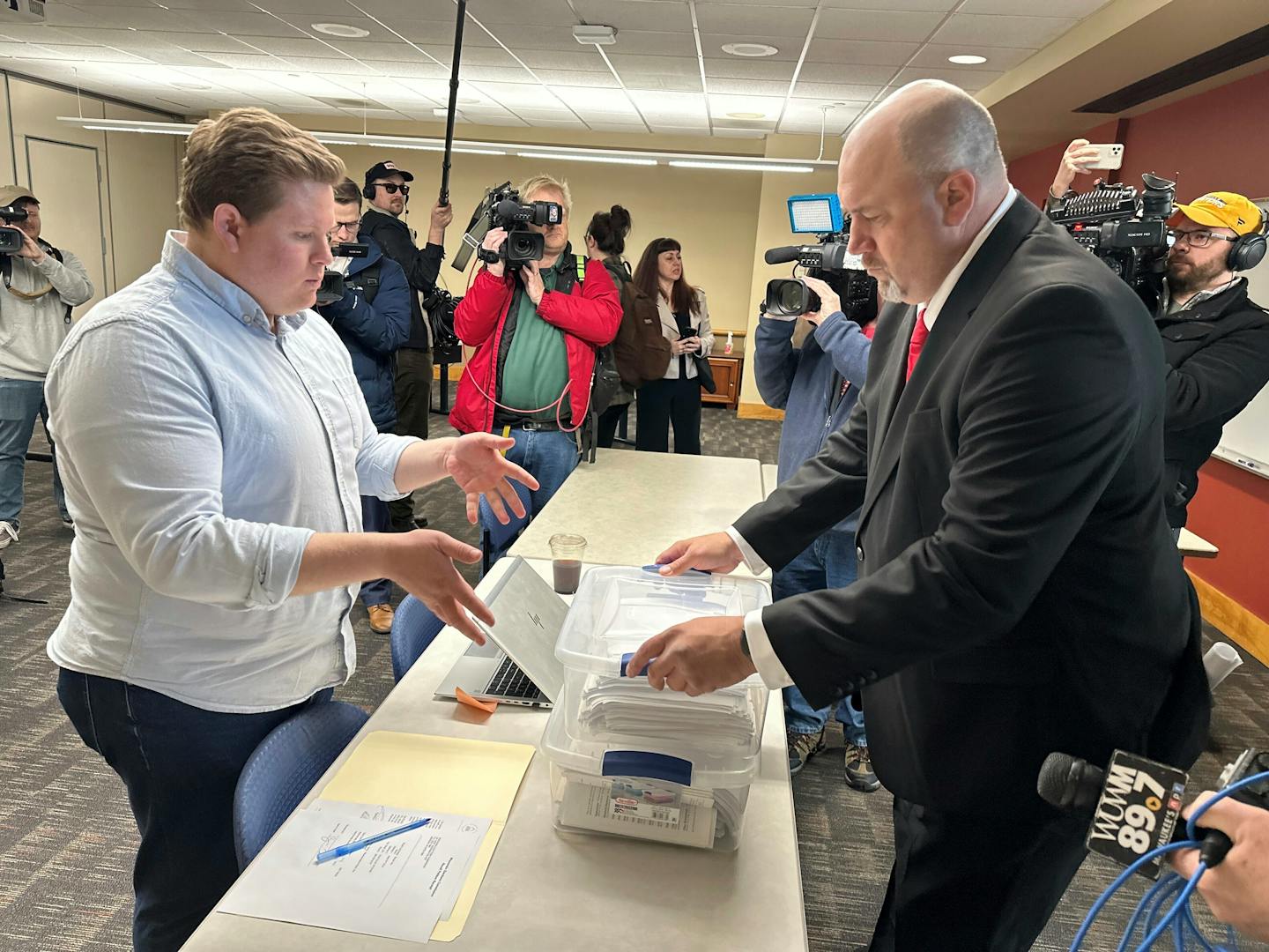 Matthew Snorek, right, submits petitions to force a recall election targeting Wisconsin's top elected Republican, Assembly Speaker Robin Vos, Monday, 