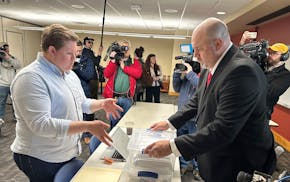 Matthew Snorek, right, submits petitions to force a recall election targeting Wisconsin's top elected Republican, Assembly Speaker Robin Vos, Monday,