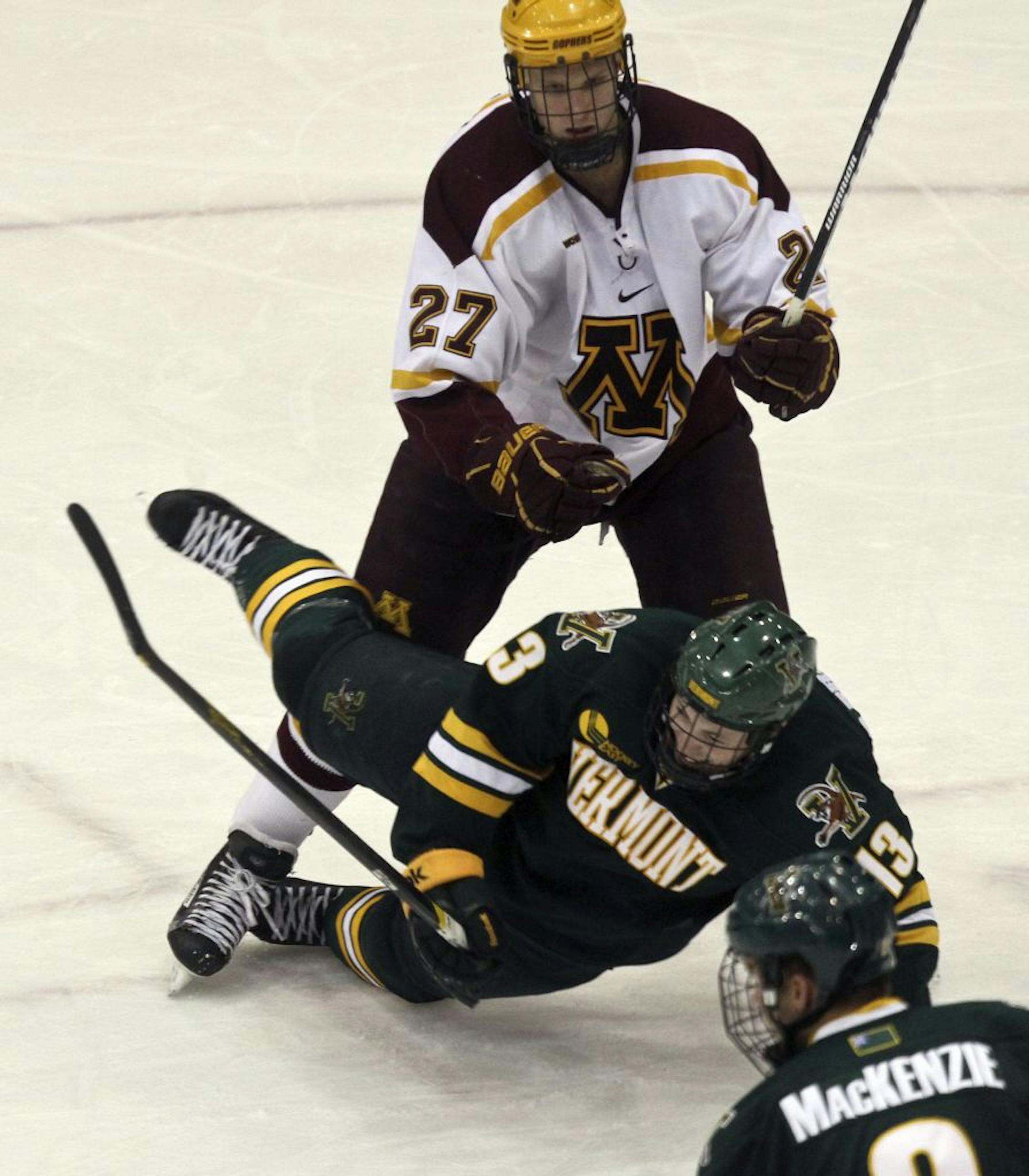 Gopher Nick Bjugstad pushed Catamount's Brett Bruneteau off the puck in the third period in Minneapolis Friday, October 21, 2011. Gophers won-6-0.
