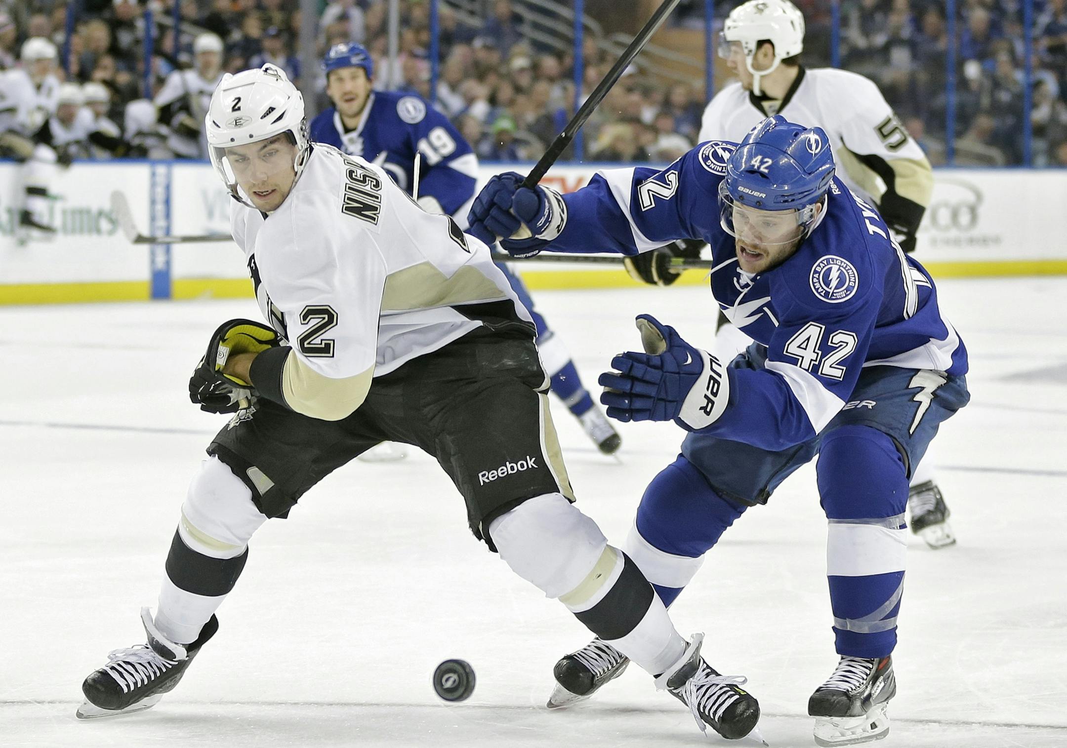 Pittsburgh Penguins defenseman Matt Niskanen (2) and Tampa Bay Lightning center Dana Tyrell (42) battle for a loose puck during the second period of an NHL hockey game on Friday, Nov. 29, 2013, in Tampa, Fla. (AP Photo/Chris O'Meara) ORG XMIT: MIN2013122019011072