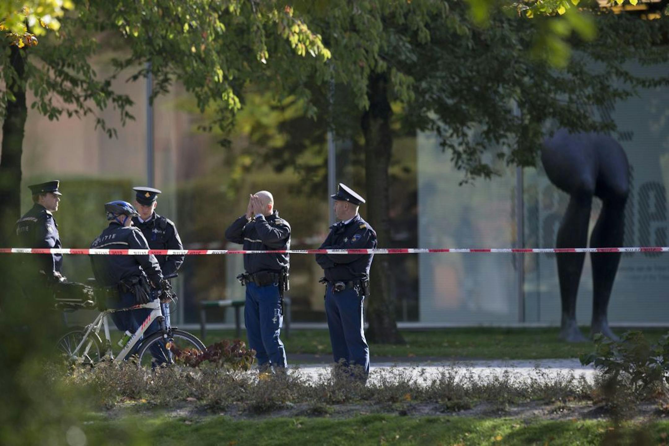 Police officers guard a cordoned off area at the rear side of the Kunsthal museum in Rotterdam, Tuesday Oct. 16, 2012. Several paintings have been stolen from a museum in the Dutch city of Rotterdam that was exhibiting works by Pablo Picasso, Henri Matisse and Vincent van Gogh. At least several paintings were stolen early Tuesday morning from the Kunsthal museum , but their names have not yet been released. They are believed to include at least one by Henri Matisse, the 1919 "Reading Girl."