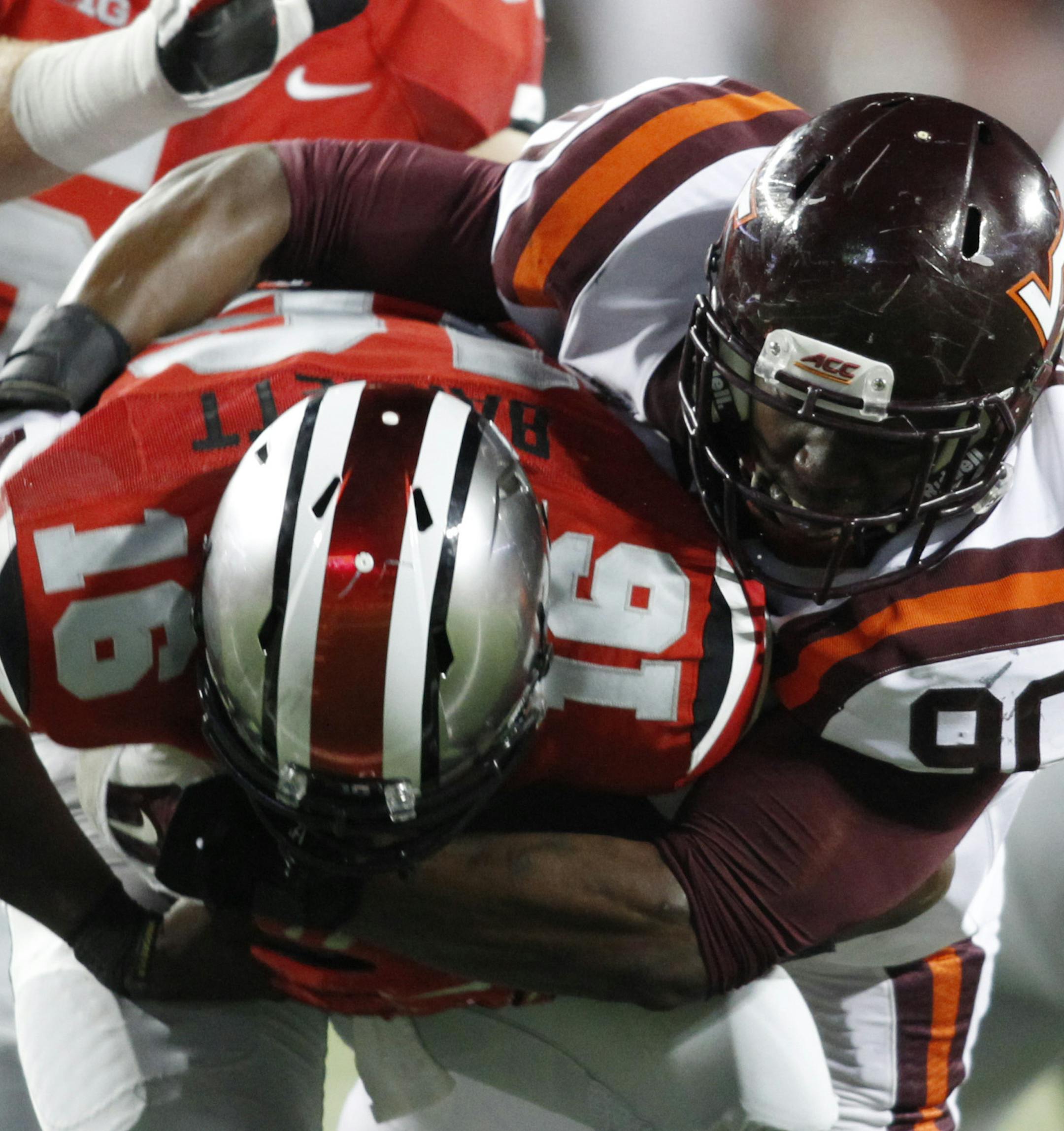 Virginia Tech defensive end Dadi Nicolas, right, sacks Ohio State quarterback J.T. Barrett during an NCAA college football game Saturday, Sept. 6, 2014, in Columbus, Ohio. Virginia Tech won 35-21. (AP Photo/Paul Vernon)