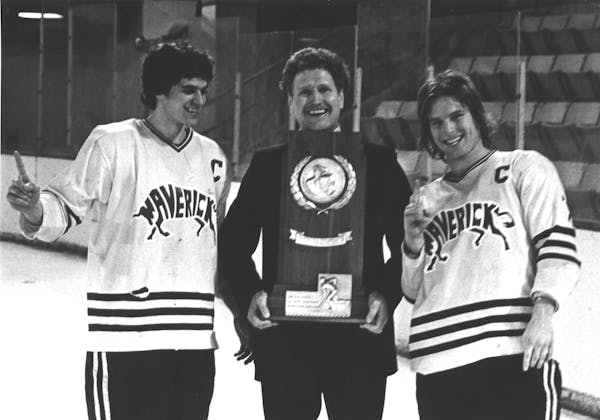 Don Brose holds Minnesota State’s 1980 NCAA Division II men’s hockey trophy with captain Steve Forliti (left) and Steve Loomis (right).
