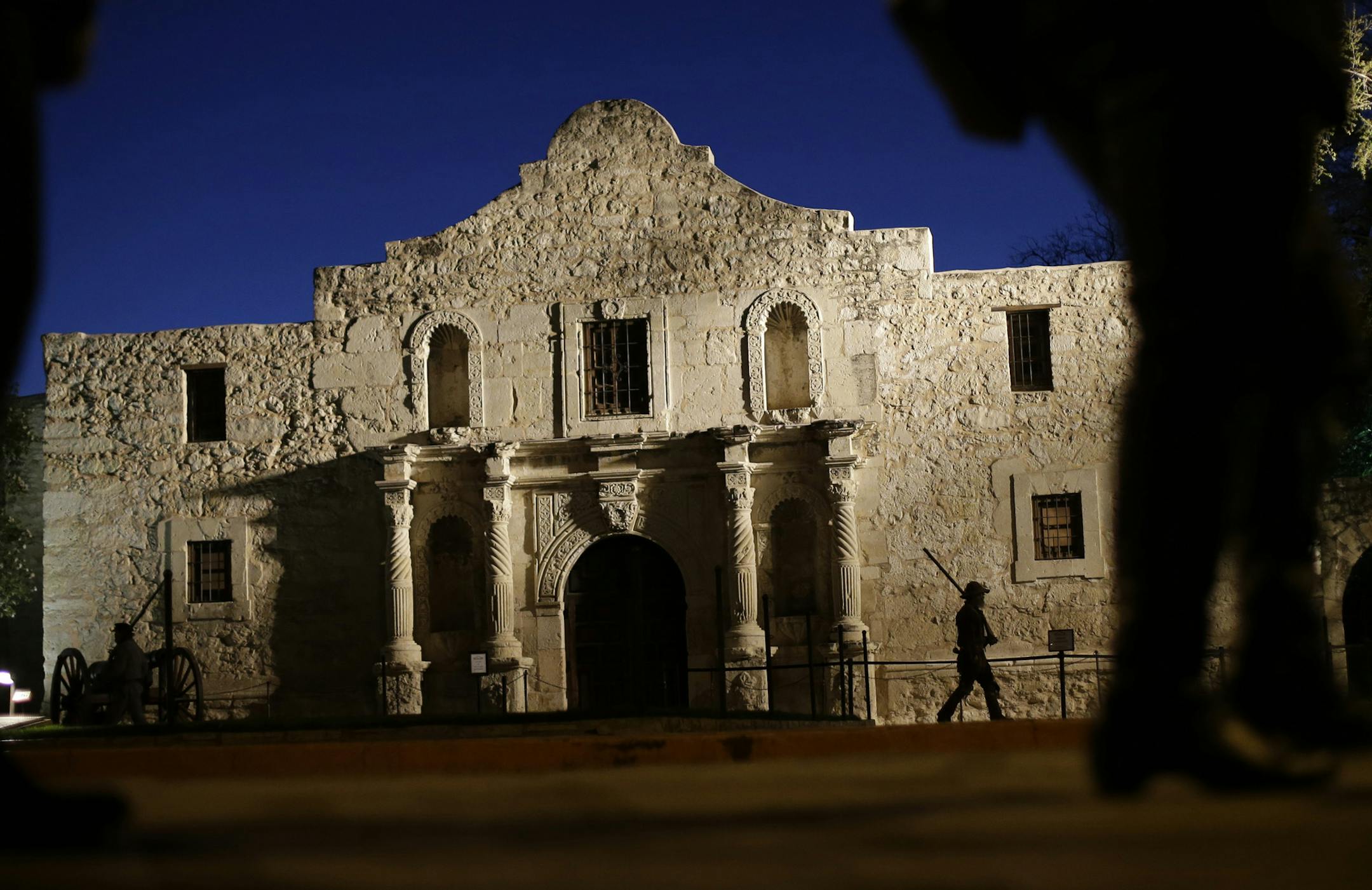 File - In this March 6, 2013, file photo, Dan Phillips, a member of the San Antonio Living History Association, patrols the Alamo during a pre-dawn memorial ceremony to remember the 1836 Battle of the Alamo and those who fell on both sides, in San Antonio. Texas is taking over management of the Alamo, ending the Daughters of the Texas Republicís 110-year management of the site, according to a joint statement issued Thursday, March 12, 2015. (AP Photo/Eric Gay, File)