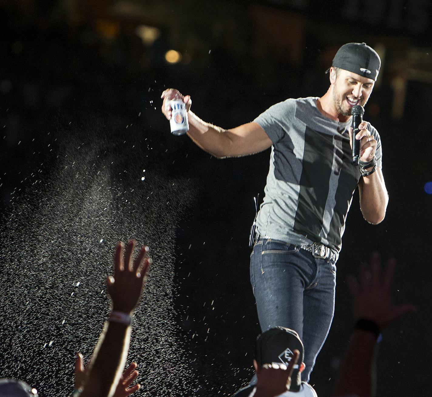 Luke Bryan pours beer on the crowd at his Kick The Dust Up Tour at TCF Bank Stadium in Minneapolis June 20, 2015. (Courtney Perry/Special to the Star Tribune)