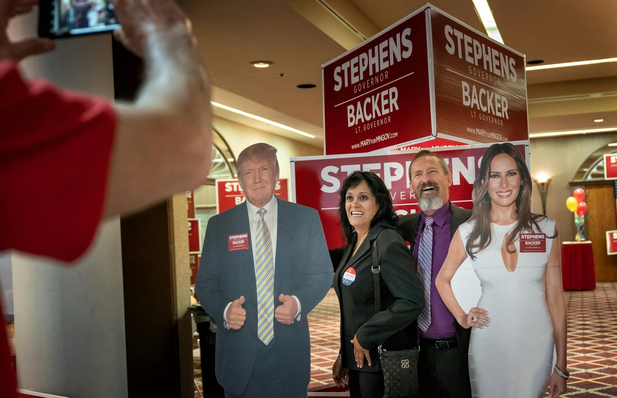 Maria Rosario and Bill Jungbauer, delegates from Inver Grove Heights wanted to take their photo by cutouts of President Trump and First Lady Melania Trump at the Republican state convention in Duluth.