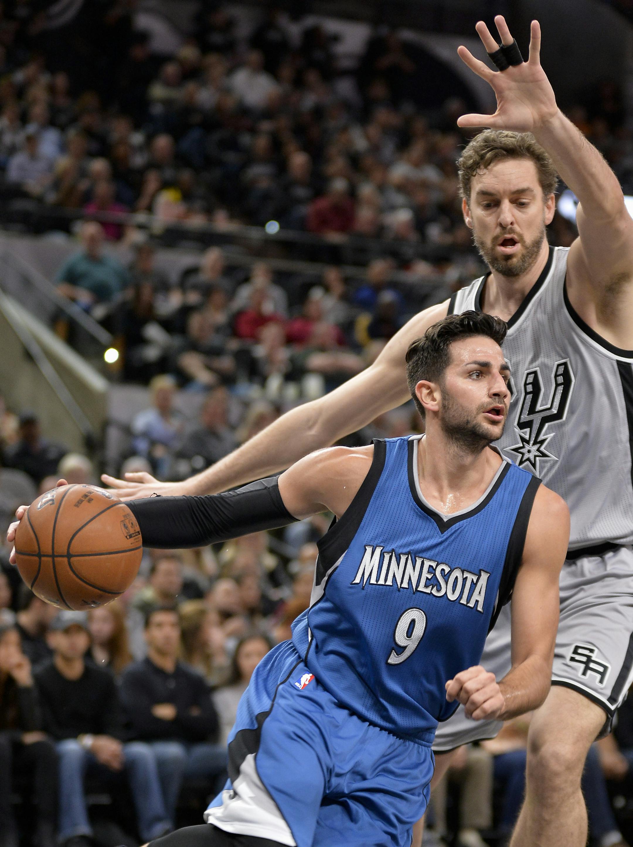 Minnesota Timberwolves guard Ricky Rubio (9), of Spain, drives around San Antonio Spurs center Pau Gasol, of Spain, during the first half of an NBA basketball game, Saturday, March 4, 2017, in San Antonio. (AP Photo/Darren Abate)