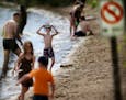 With temps soaring into the high 80s, the traffic on the Lake Harriet beach resembled more July than May Friday, May 6, 2016, in Minneapolis, MN.](DAV