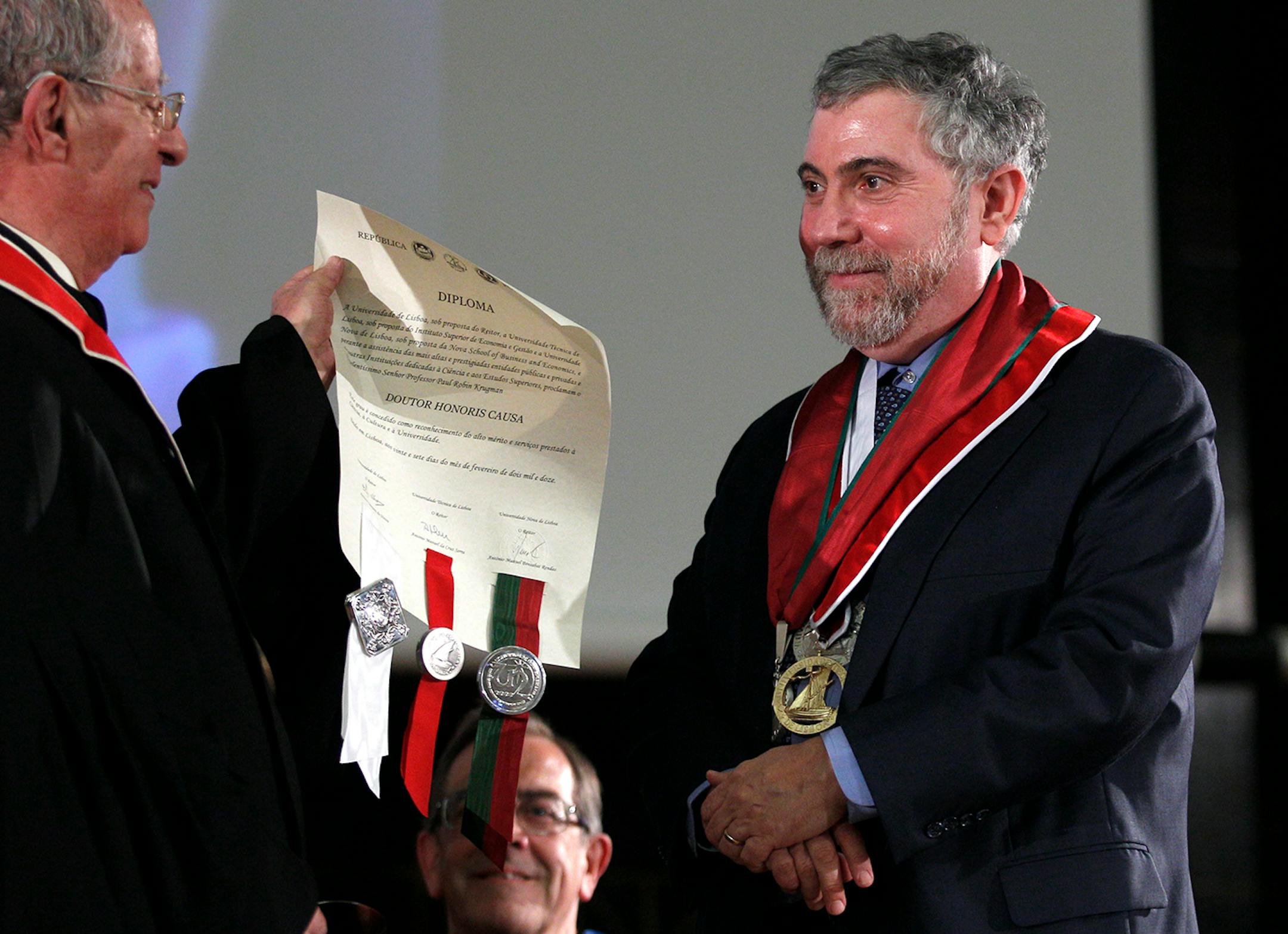 American economy Nobel Prize laureate Paul Krugman, right, is awarded an Honoris Causa degree by Lisbon University, Lisbon Technical University and Lisbon Nova University Monday, Feb. 27, 2012 in Lisbon. (AP Photo/ Francisco Seco)