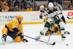 Minnesota Wild center Frederick Gaudreau (89) is defended by Nashville Predators' Ryan McDonagh (27) during the first period of an NHL hockey game Thu