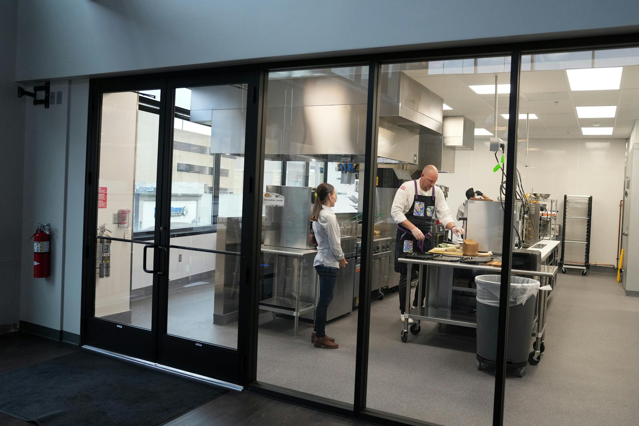 Taco John's culinary assistant Andy Cook prepares food for an executive team menu showing at the company's new restaurant support center and test kitchen.