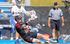 Eden Prairie's Will Foster (15) went to the turf but still got his shot on goal in the first half of a state boys' lacrosse semifinal against Prior La
