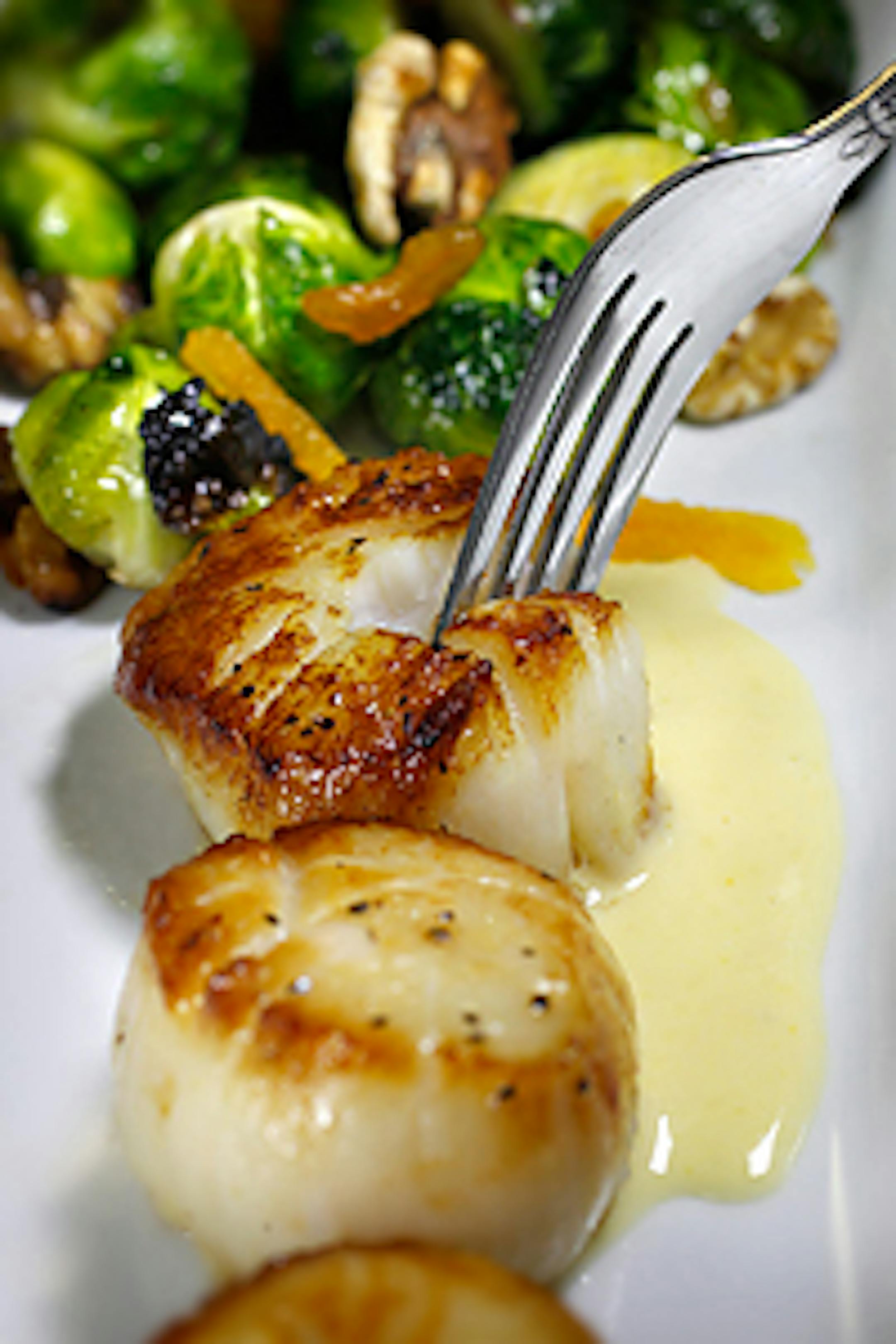 Massachusetts day boat scallops with caramelized brussels sprouts, walnuts and dried apricots