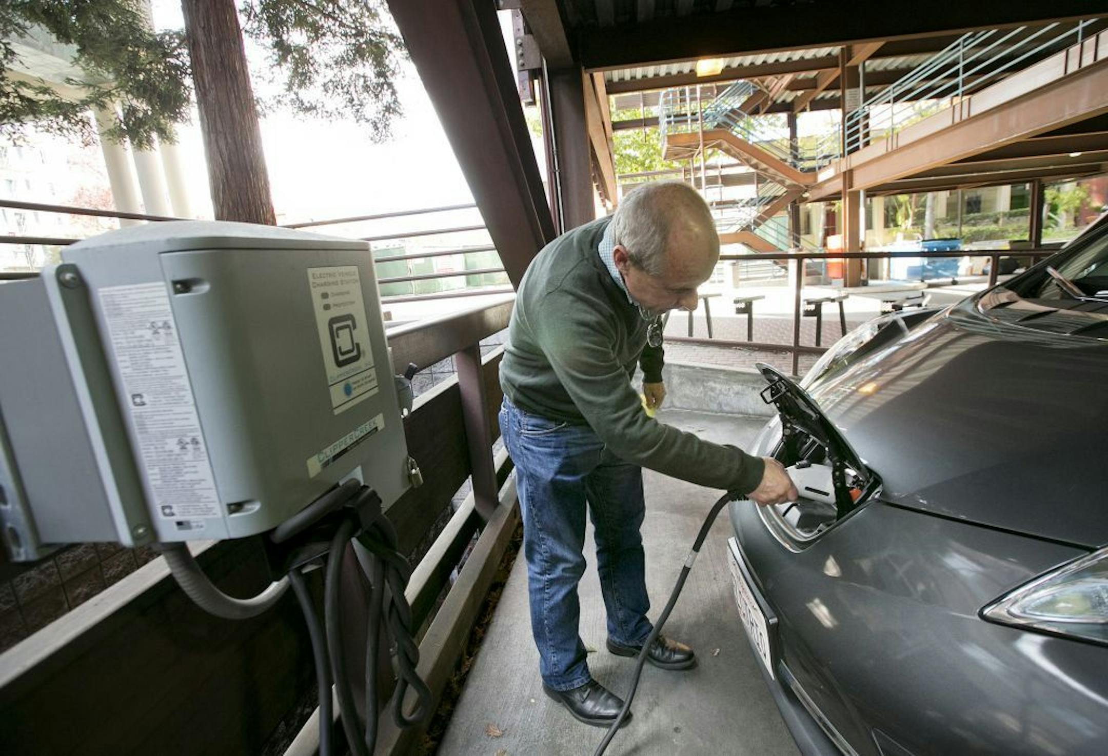 A Nissan Leaf electric car is charged at the City of Palo Alto EV charging station in the public garage in Palo Alto, Calif., on November 5, 2015.