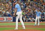 Tampa Bay Rays starter Zach Eflin checks the runner at first base during the fourth inning of a baseball game against the Seattle Mariners, Sunday, Se
