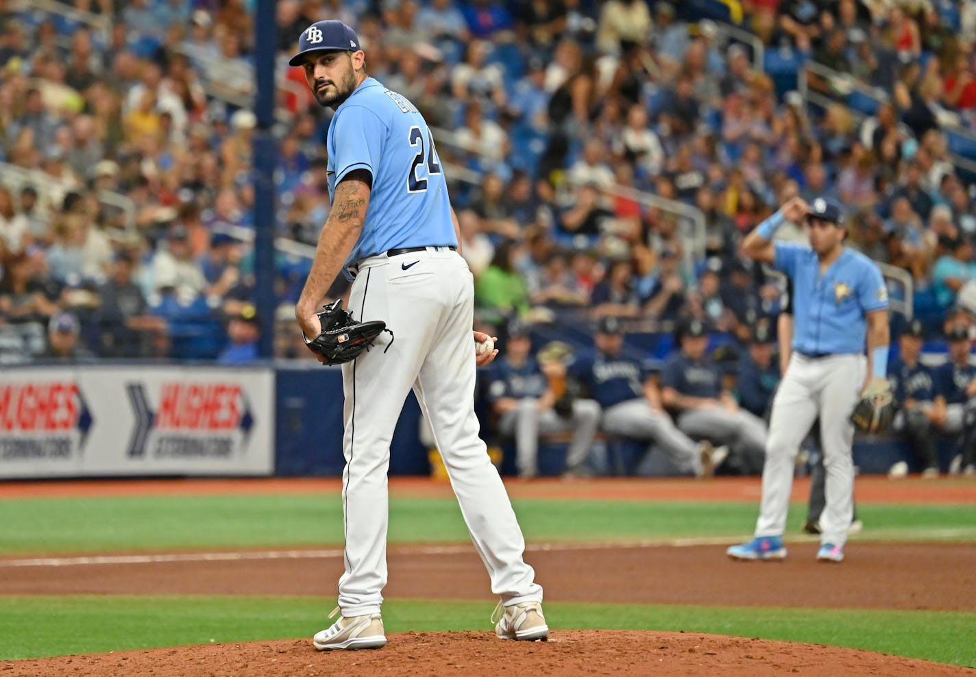 Tampa Bay Rays starter Zach Eflin checks the runner at first base during the fourth inning of a baseball game against the Seattle Mariners, Sunday, Sept. 10, 2023, in St. Petersburg, Fla. (AP Photo/Steve Nesius)