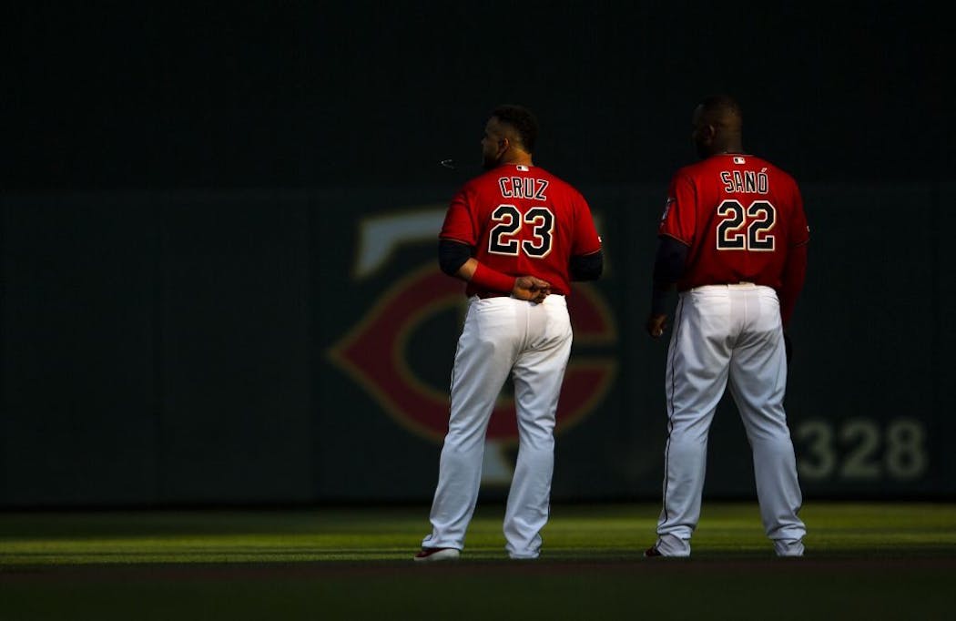 Nelson Cruz and Miguel Sano stood together during the national anthem before a game this summer.