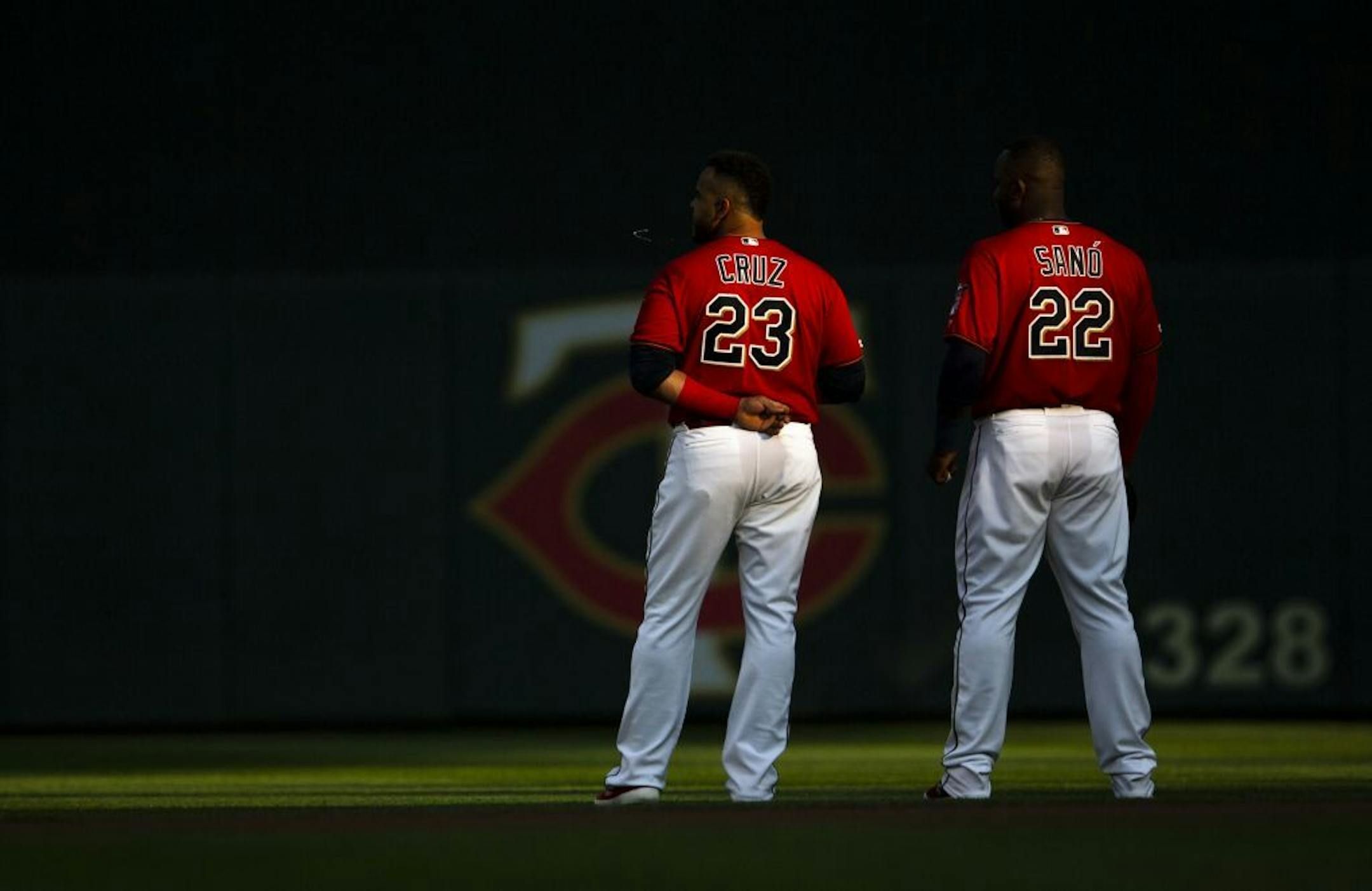 Nelson Cruz and Miguel Sano stood together during the national anthem before a game this summer.