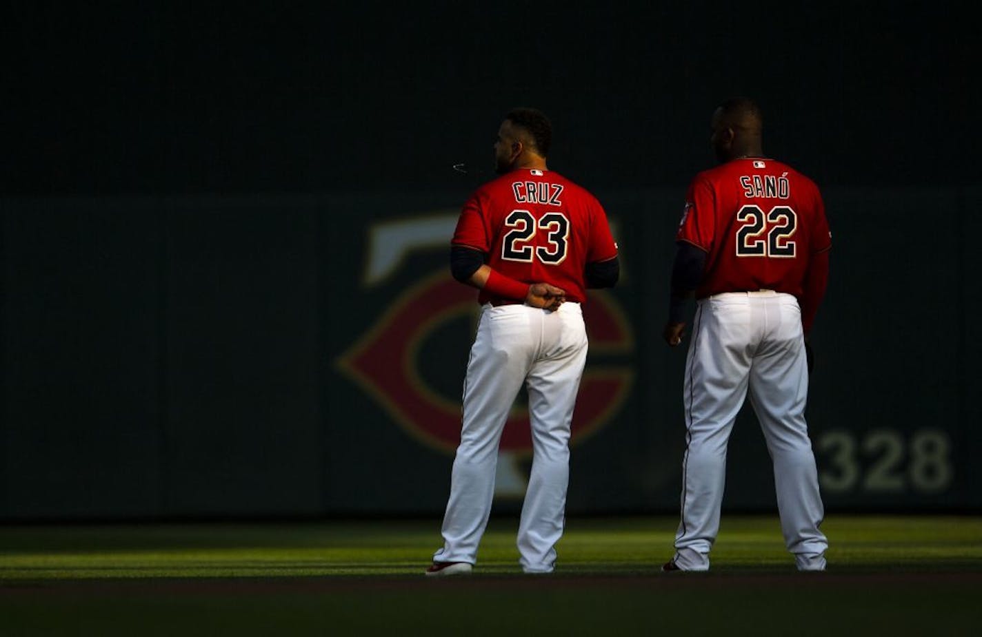 Nelson Cruz and Miguel Sano stood together during the national anthem before a game this summer.