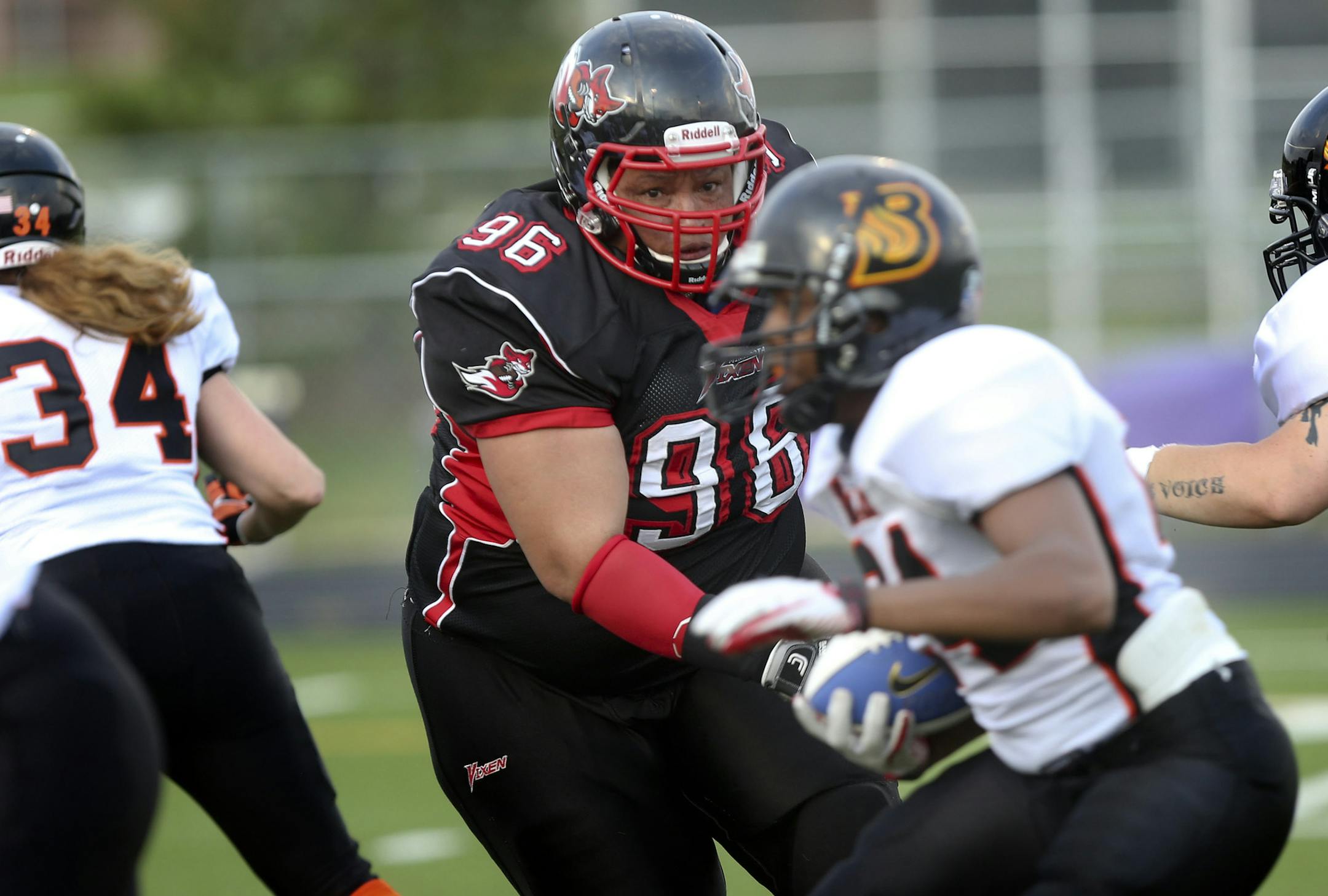 Hard-hitting Cynthia “Red” Bryant of the Minnesota Vixen, a women’s tackle football team, closed in on Madison (Wis.) Blaze running back Kara Haines during a recent game played at Chaska High School. She’s played for the team since 1998. “I’m blessed,” Bryant said. “I’m able to be agile and hostile at 40.”