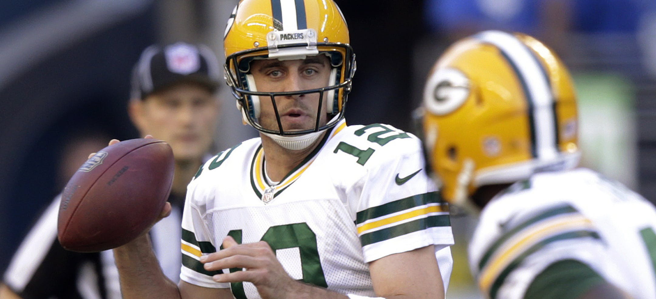 Green Bay Packers quarterback Aaron Rodgers looks to pass against the Seattle Seahawks in the first half of an NFL football game, Thursday, Sept. 4, 2014, in Seattle. (AP Photo/Stephen Brashear)
