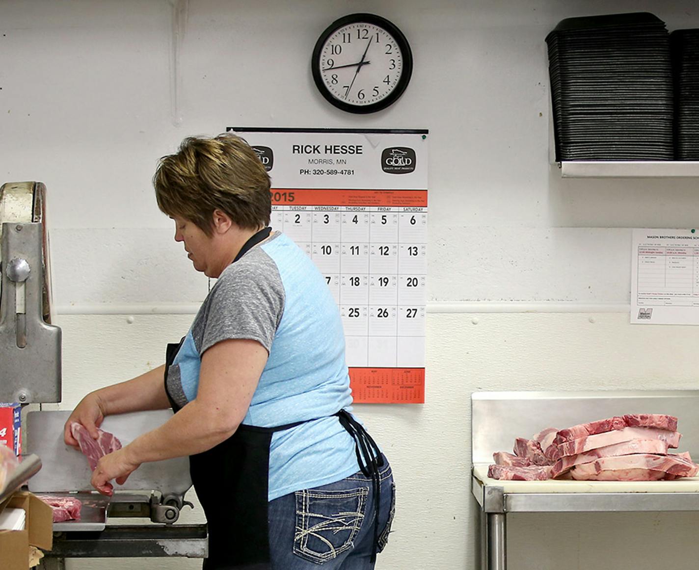 Bonnie Carlson spent part of her morning cutting and packaging her own meat, Tuesday, June 23, 2015. Carlson is the owner and operator of Bonnie's Hometown Grocery. She bought the store 15 years ago when it was on the brink of closure. Last spring, when she needed a new, $30,000 freezer, the community stepped up, funding a Kickstarter campaign to purchase one. ] (ELIZABETH FLORES/STAR TRIBUNE) ELIZABETH FLORES &#xef; eflores@startribune.com ORG XMIT: MIN1507020831570465