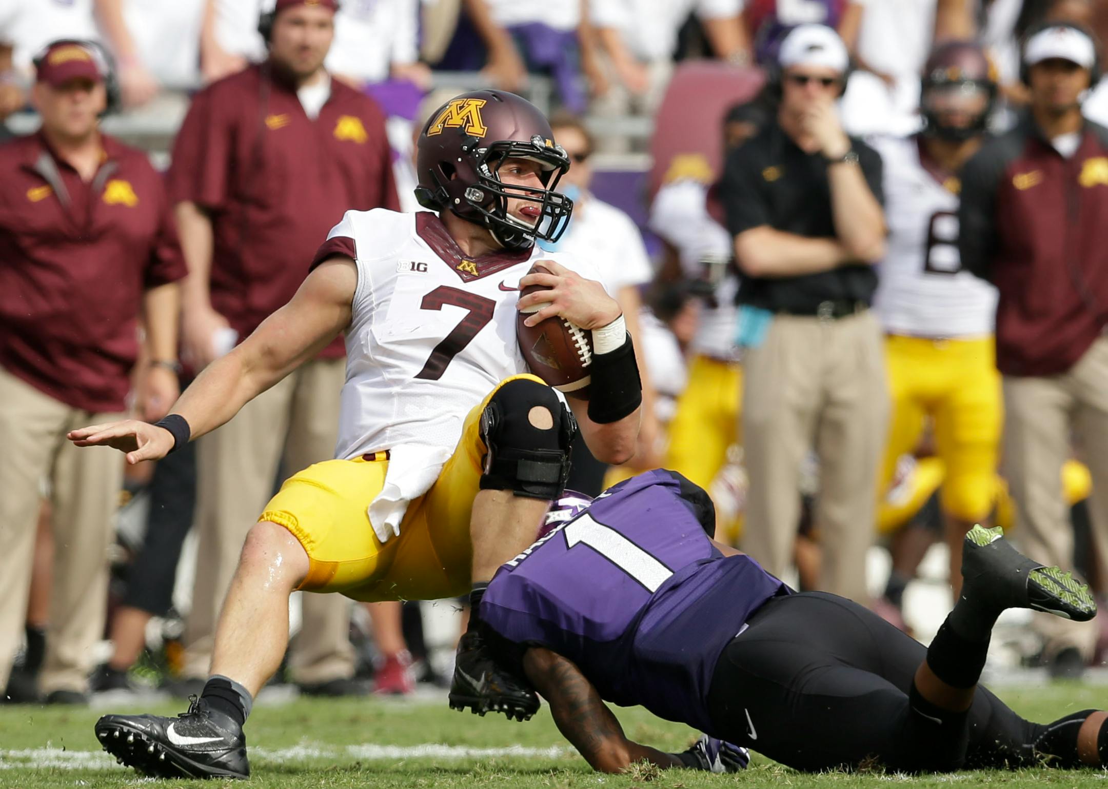 Minnesota quarterback Mitch Leidner (7) is stopped by TCU safety Chris Hackett (1) during the first half of an NCAA college football game Saturday, Sept. 13, 2014, in Fort Worth, Texas. (AP Photo/LM Otero)